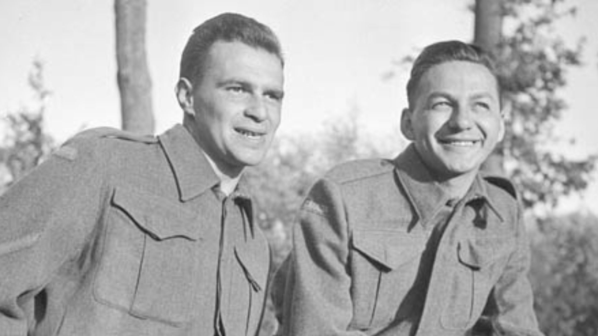 Sergeant Johnny Wayne and Staff-Sergeant Frank Shuster (Wayne and Shuster) of the Canadian Army Show relaxing before a performance of their comedy show for personnel of the 2nd Canadian Infantry Division.