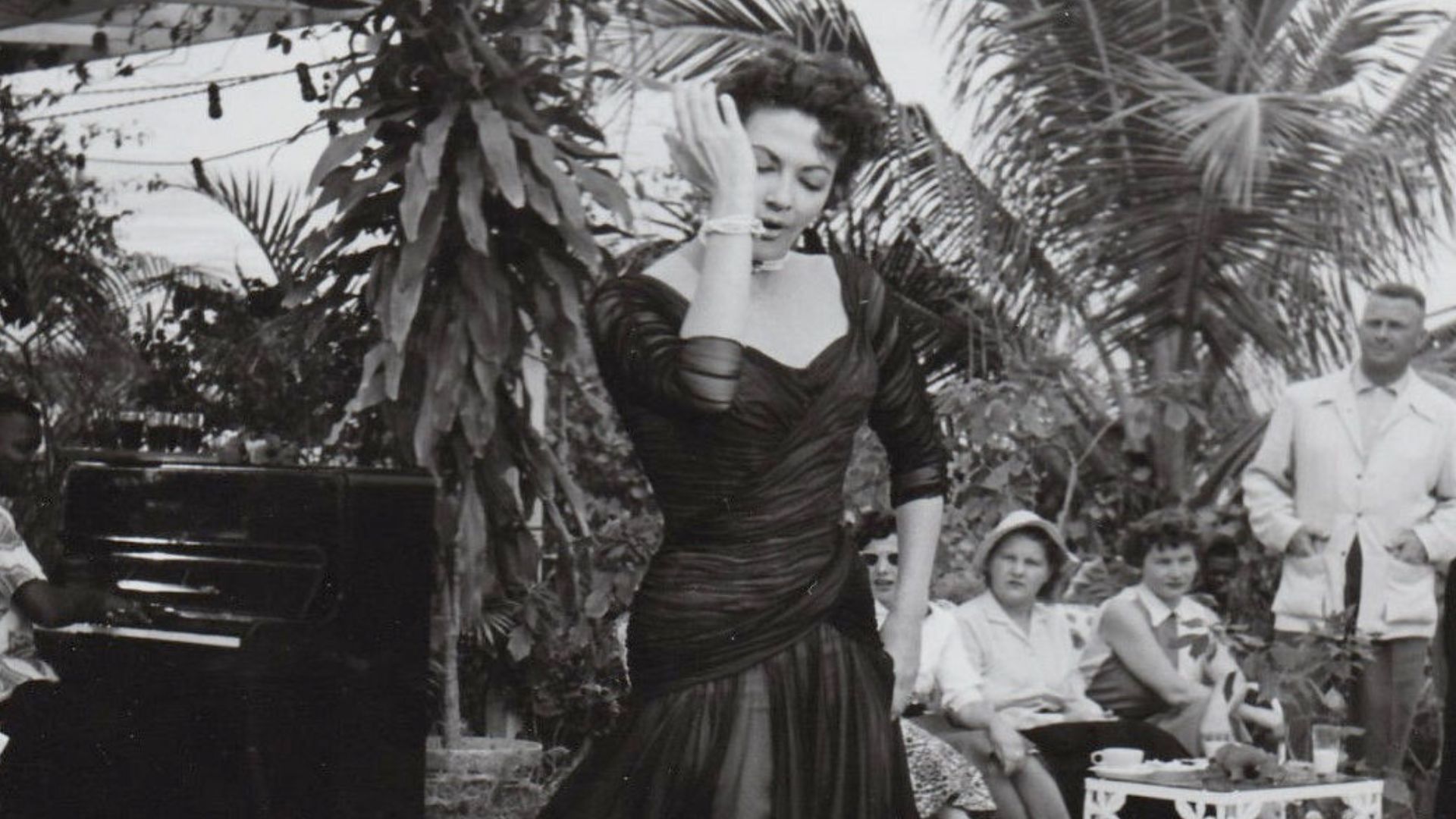 Press photo of Yvonne De Carlo dancing for the film Flame of the Islands (1956).