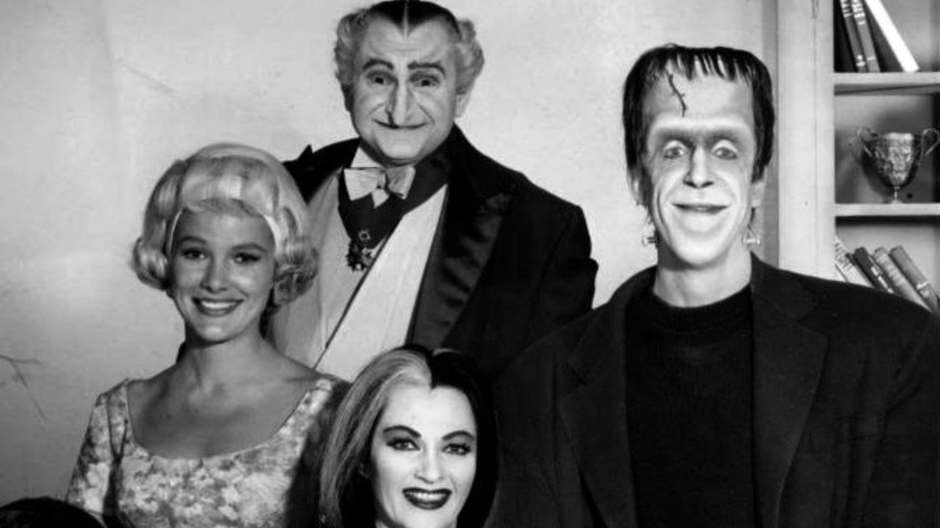 Publicity photo of the cast of the television program The Munsters.  Seated, from left: Butch Patrick (Eddie), Yvonne DeCarlo (Lilly), Fred Gwynne (Herman).  Standing: Beverly Owen (Marilyn) and Al Lewis (Grandpa).