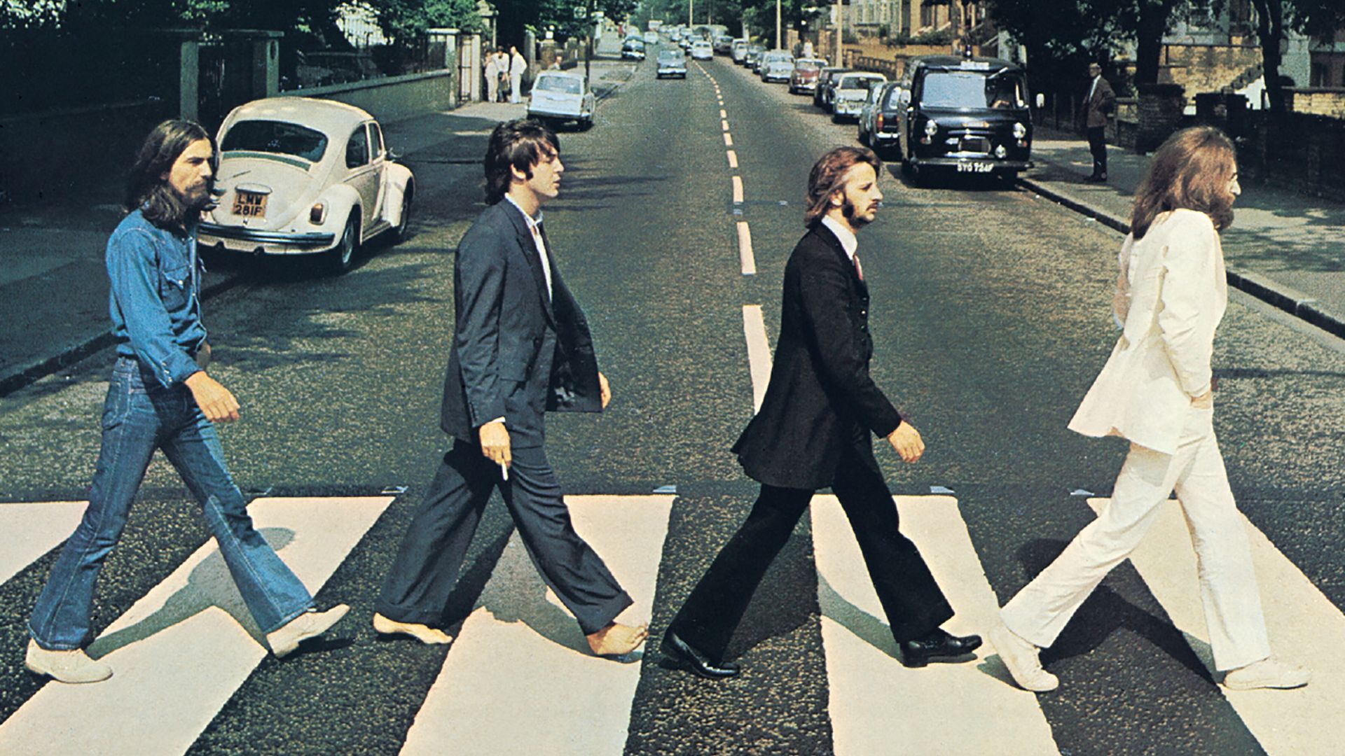 Front cover of Abbey Road by The Beatles. The view really is Abbey Road, London, NW8 looking north.  The gates of the Abbey Road Studios are behind the white VW Beetle on the left.