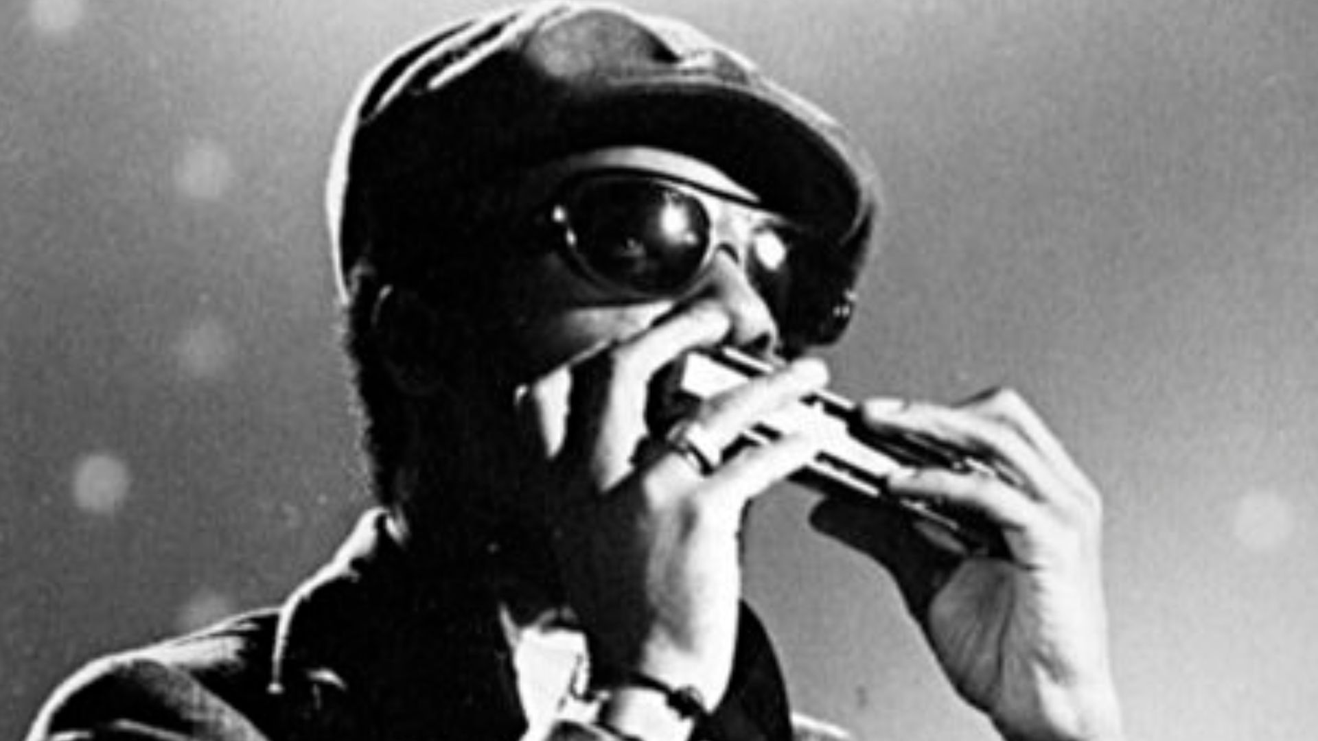 Stevie Wonder playing the harmonica in the 1970s. This image is a crop of this: https://commons.wikimedia.org/wiki/File:Burt_Bacharach_-_jam_session.jpg