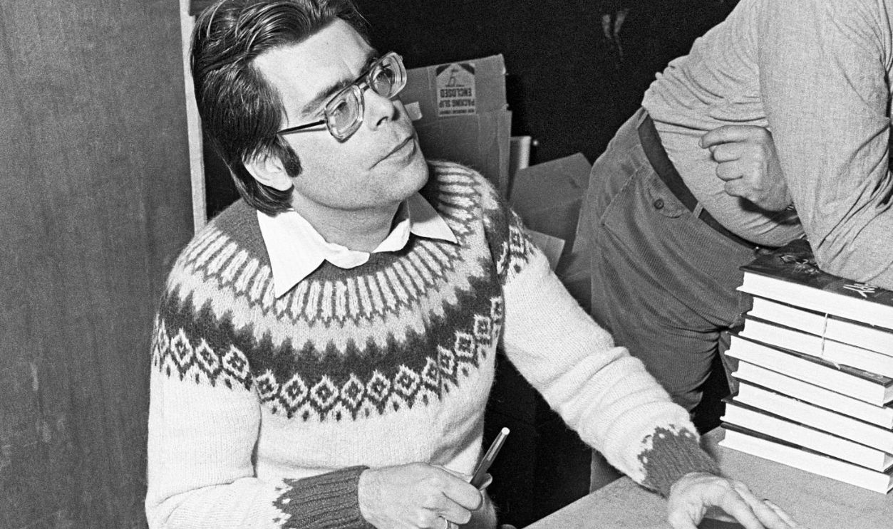 Writer, novelist, author Stephen King, signing copies of Cujo, Salem's Lot, and other books at a book signing party in Truth or Consequences, New Mexico, circa 1976