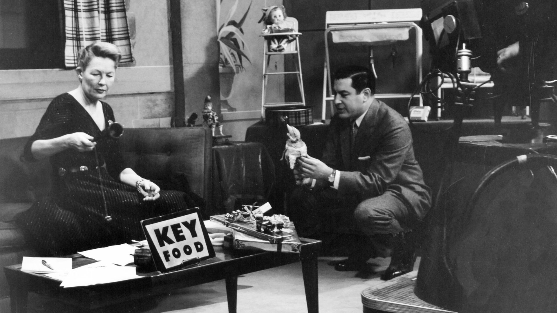 D. Dudley Bloom Amsco Toys sponsored The Wendy Barrie Show on the Dumont Television Network, soon to become ABC. Here, Bloom prepares Barrie for an Amsco commercial spot.