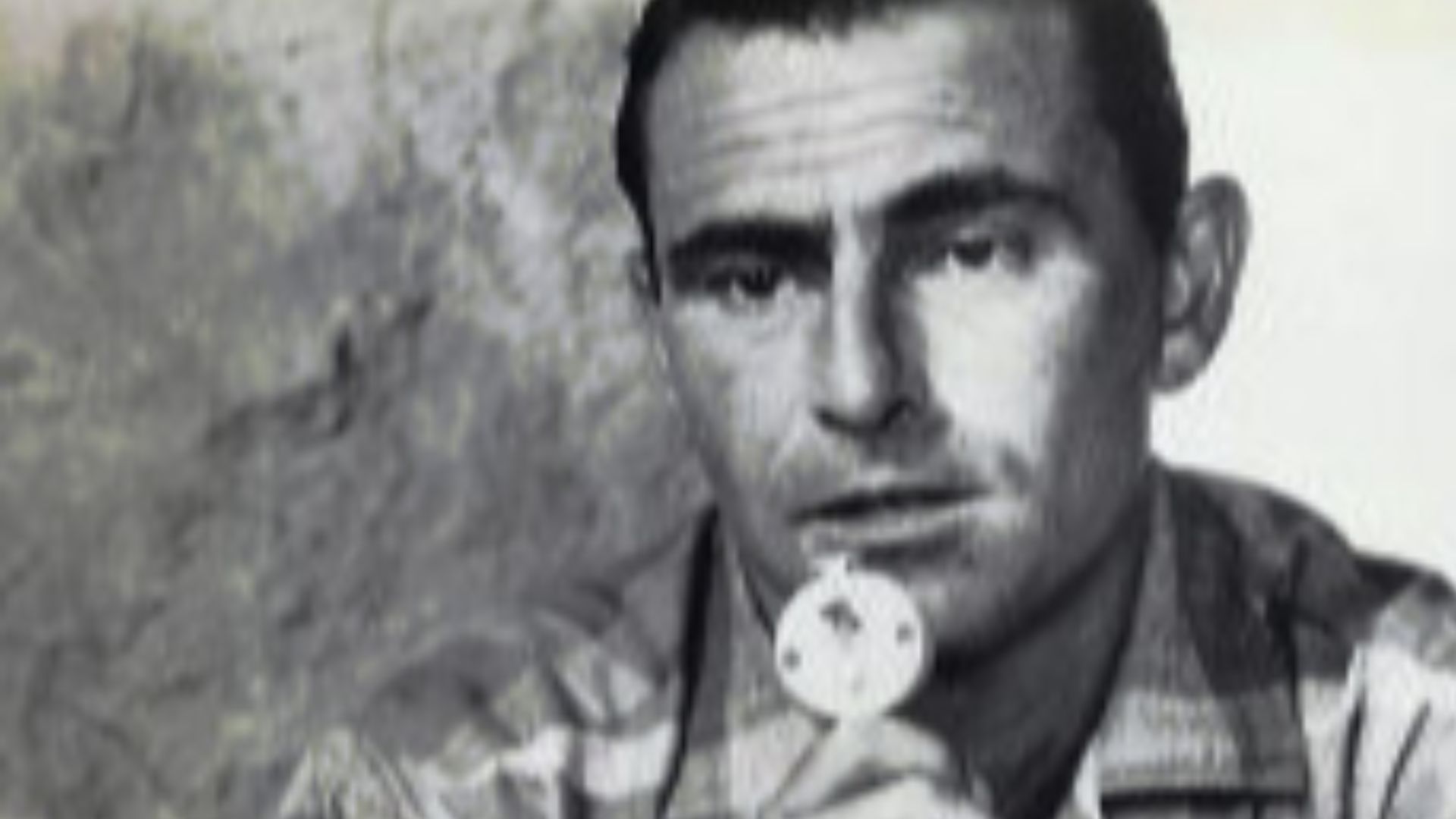 Photo of Rod Serling working on a script with a dictating machine.