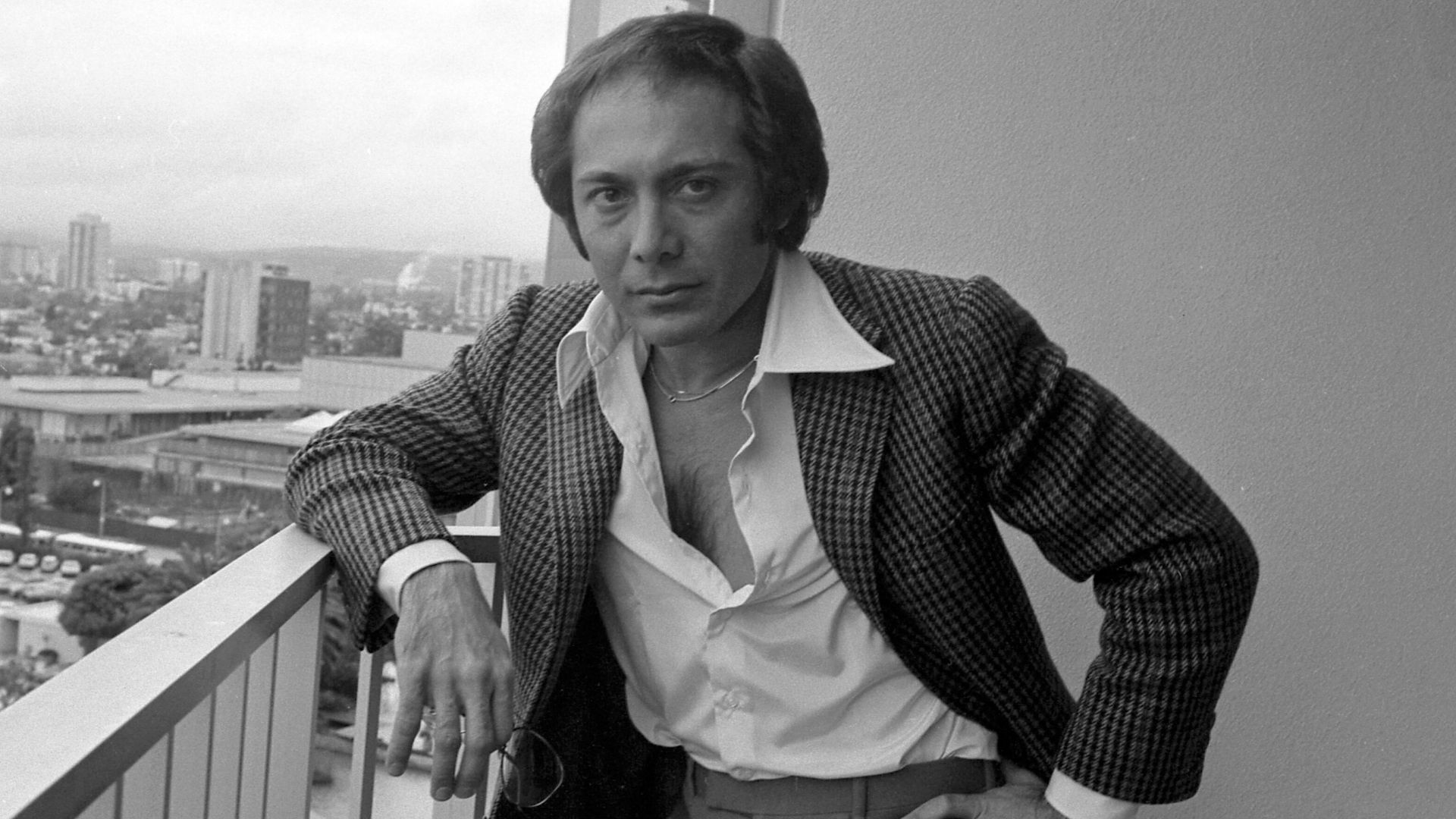 Singer Paul Anka standing on balcony in Los Angeles.
Original caption: