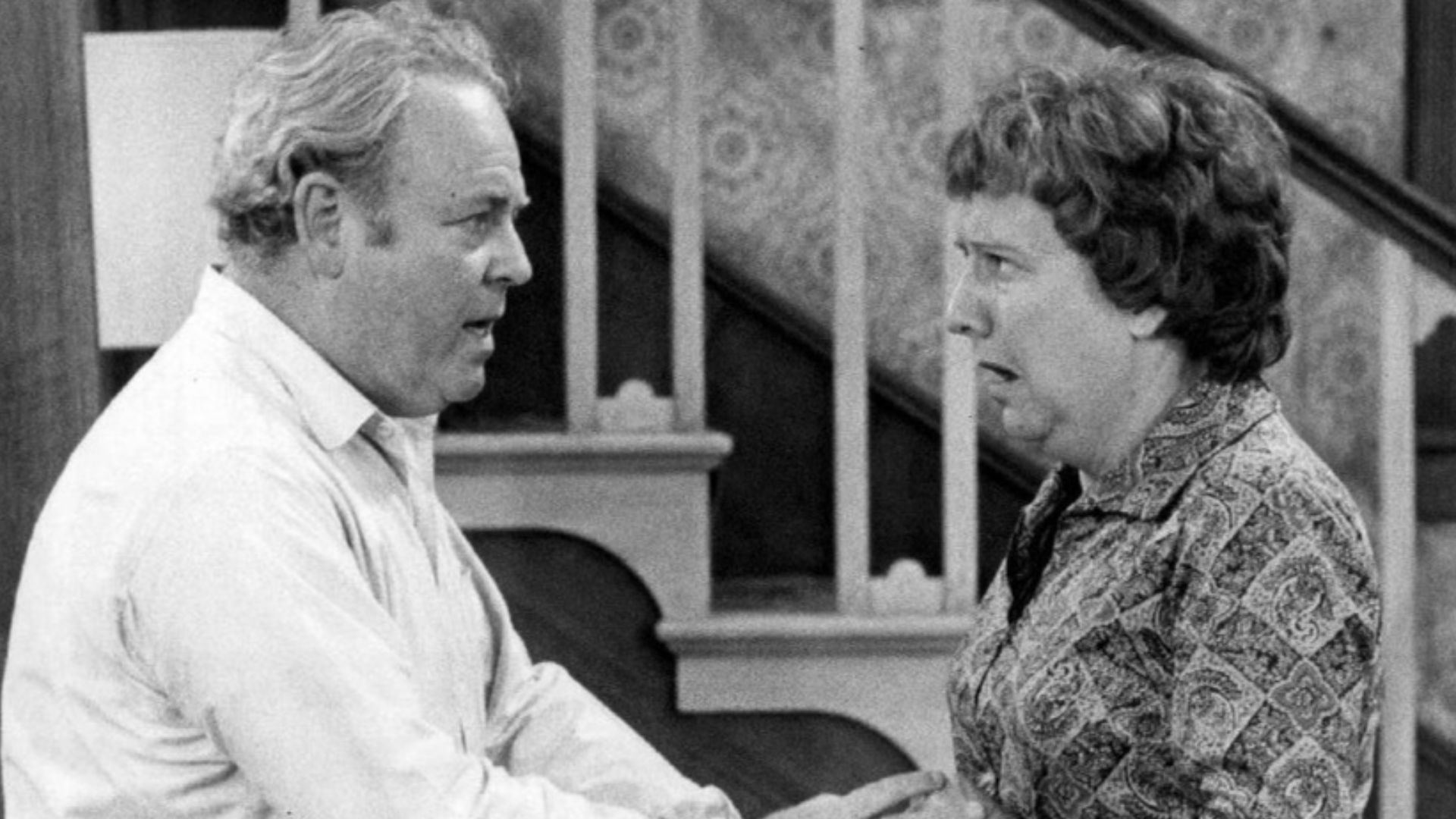 Photo of Carroll O'Connor and Jean Stapleton as Archie and Edith Bunker from the television program All In the Family.  When Archie comes home in a great mood with gifts for everyone in the family, happiness turns to shock and anger when it's discovered h