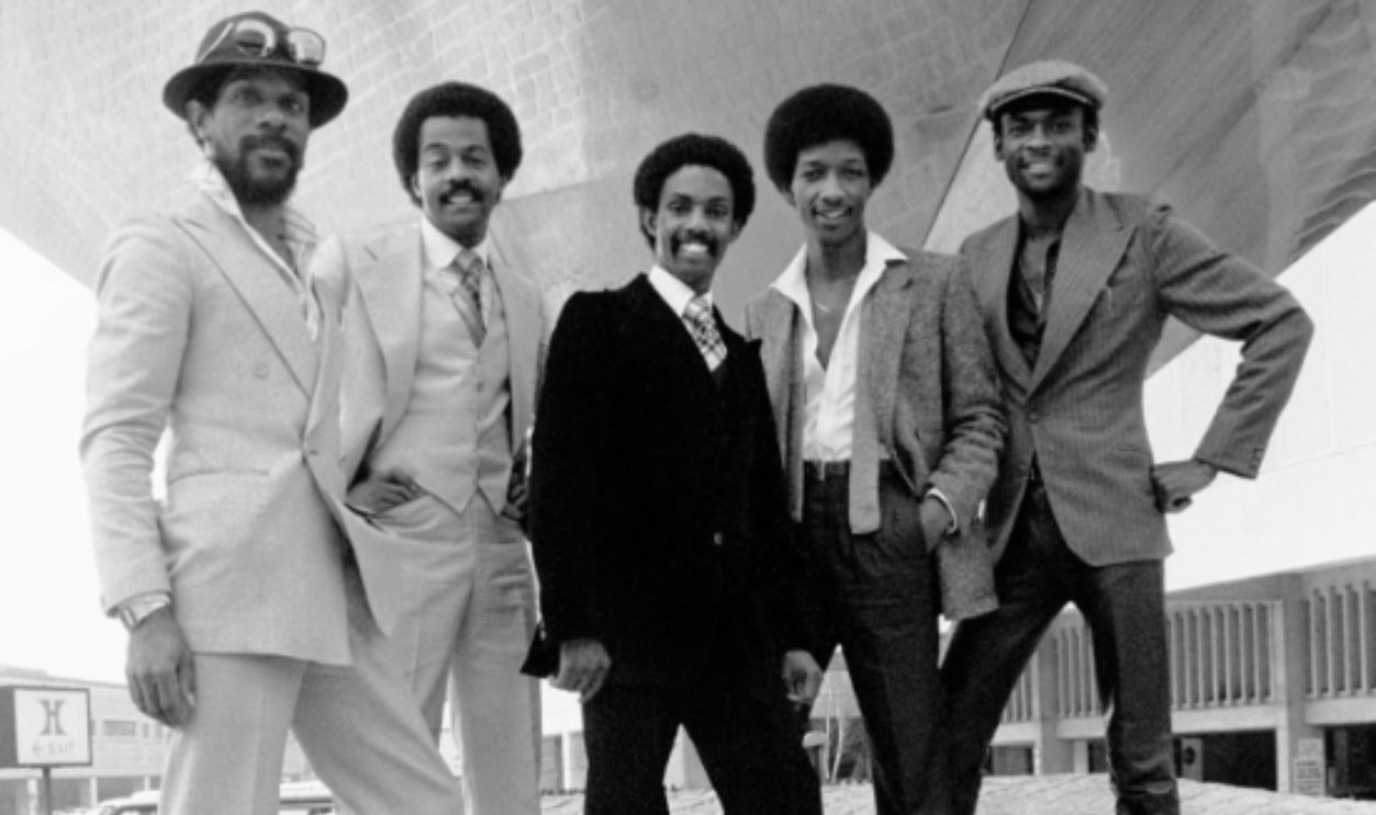 Portrait of members of the American R&B, Disco, & Funk group Kool and the Gang as they pose outdoors, Newark, New Jersey, September 27, 1979. Pictured are, from left, Dennis 'DT' Thomas (1951 - 2021), Ronald Bell (later known as Khalis Bayyan, 1951 - 2020), Robert 'Kool' Bell, James 'JT' Taylor, and George Brown (1949 - 2023). They were visiting a Two Guys department store to promote their 'Ladies Night' album. 