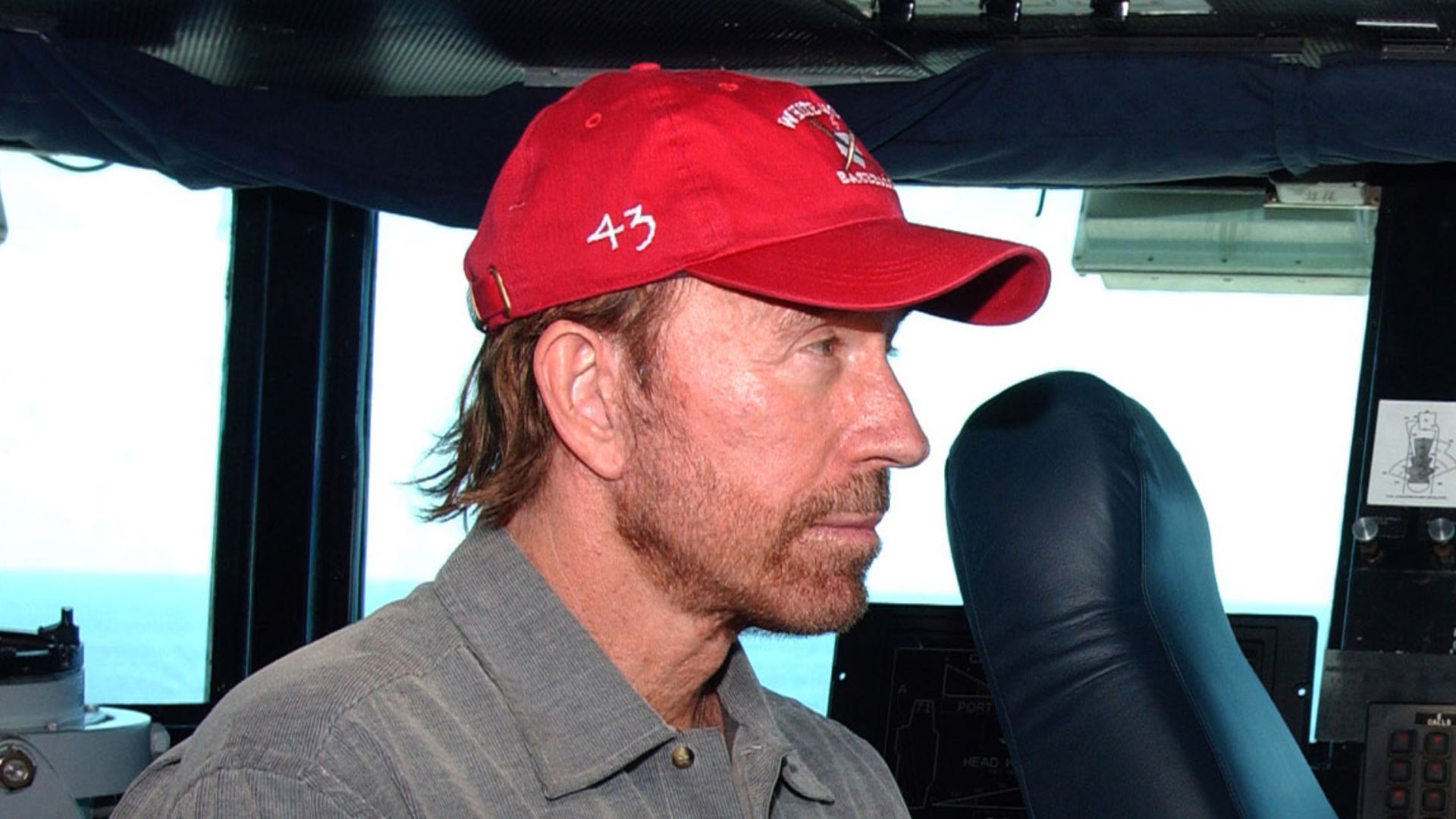 Actor and President of Topkick Productions, Chuck Norris, talks with USS Theodore Roosevelt (CVN 71) Commanding Officer, Captain J.R Haley, on the bridge of the ship during a recent visit. Roosevelt is underway in the Atlantic Ocean conducting Composite T