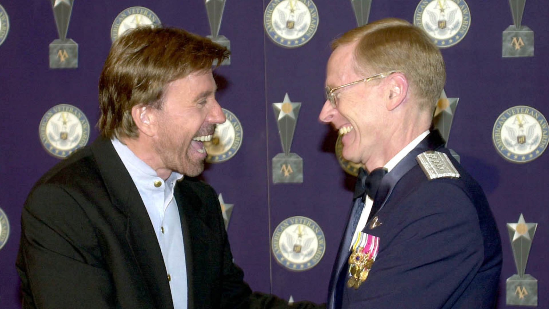 Beverly Hills, California -- Vice Chief of Staff of the Air Force, General John W. Handy, presents actor Chuck Norris with the