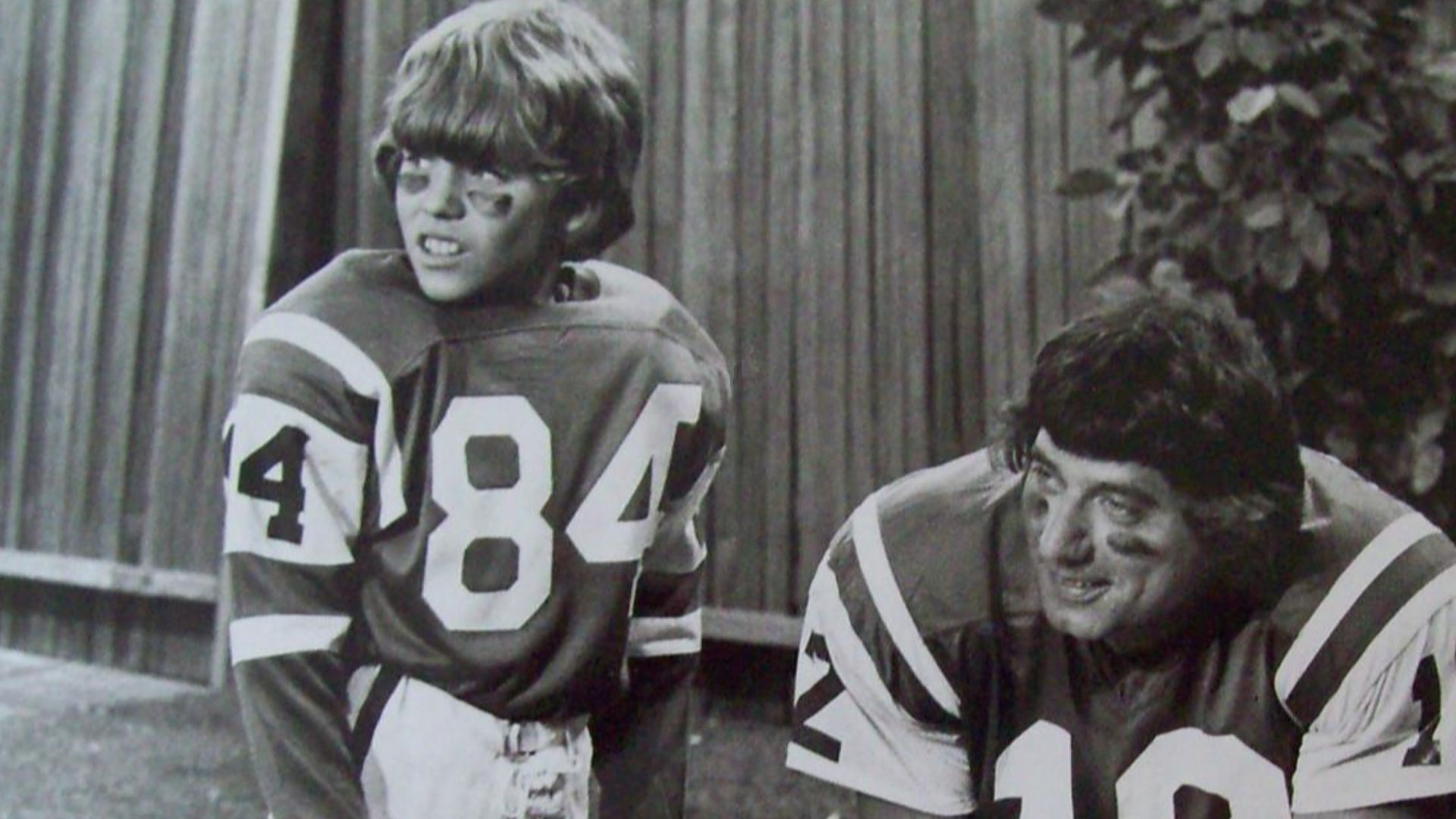 Photo of football player Joe Namath and Mike Lookinland (Bobby) from the television program The Brady Bunch.  When Bobby brags to his friends that he knows Joe Namath personally, he has to find a way to prove what he's been saying.