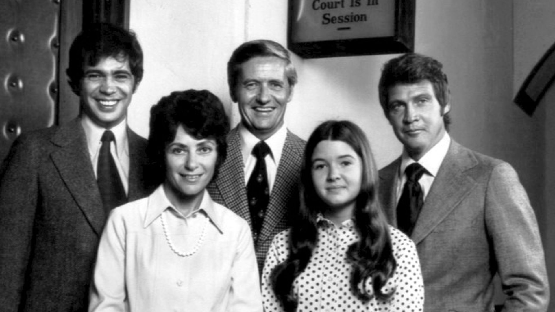 Cast photo for the television program Owen Marshall: Counselor at Law. From left, back-Reni Santori (Danny Paterno), Arthur Hill (Owen Marshall), Lee Majors (Jess Brandon).  Front, from left, Joan Darling (Frieda Krause), Christine Matchett (Melissa Marsh
