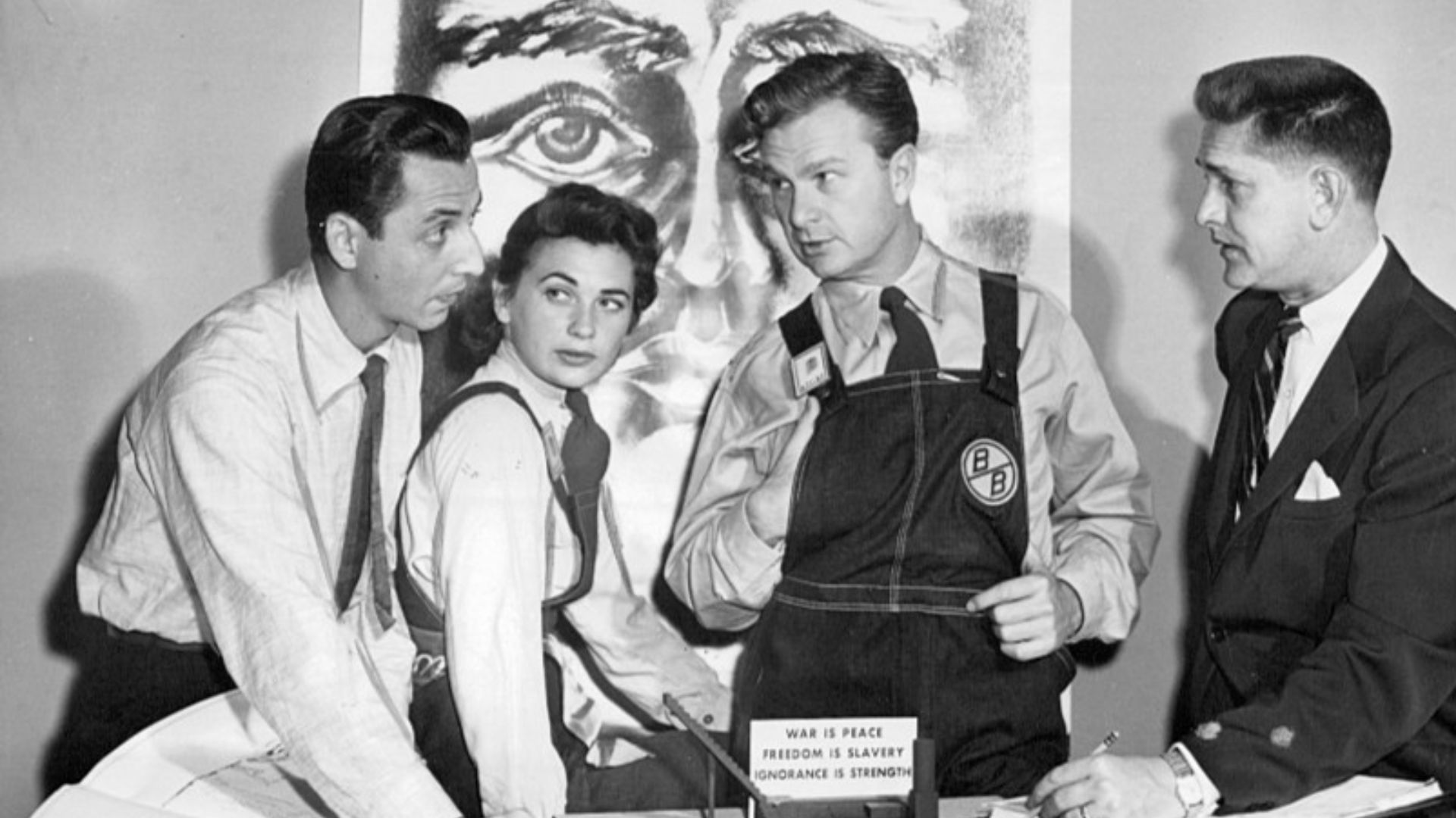 Publicity photo on the set of the CBS anthology television series Studio One.  This was a presentation of George Orwell's 1984.  L-R: scenic designer Kim Swados, Norma Crane, Eddie Albert, and director Paul Nickell