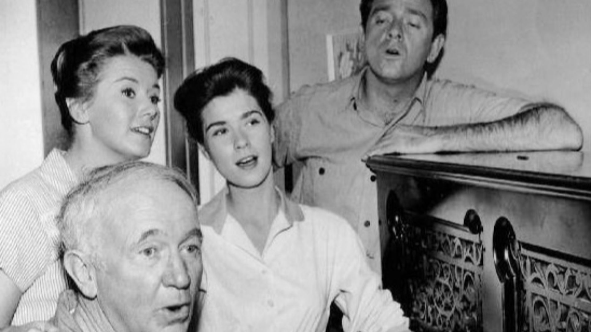Photo of the McCoy family from the television program The Real McCoys.  Kate (Kathleen Nolan), Hassie (Lydia Reed) and Luke (Richard Crenna) join Grandpa Amos (Water Brennan) in song as he plays the family's new piano.
