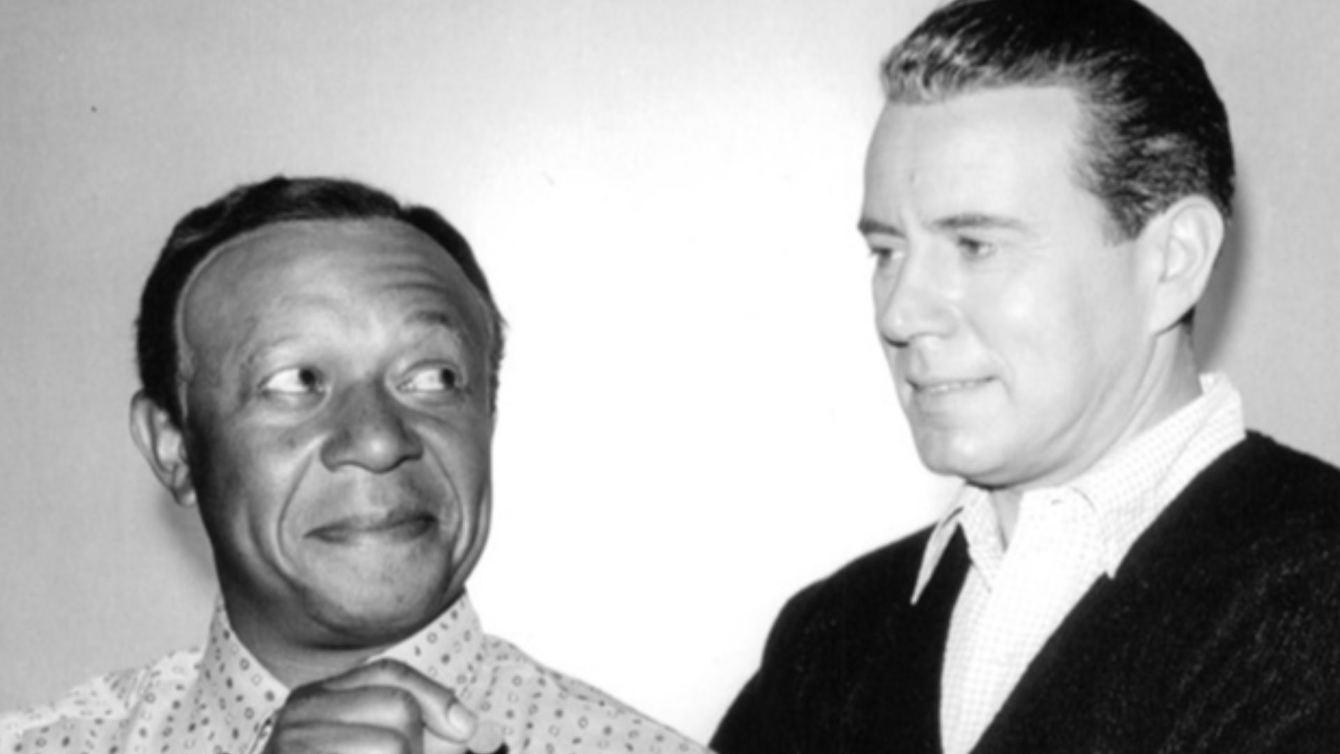 Publicity photo from Bachelor Father. Pictured are Rochester (Eddie Anderson) and Bentley Gregg (John Forsythe). In this episode, Bentley borrows Rochester from Jack Benny, hoping to learn how Benny can be so thrifty.