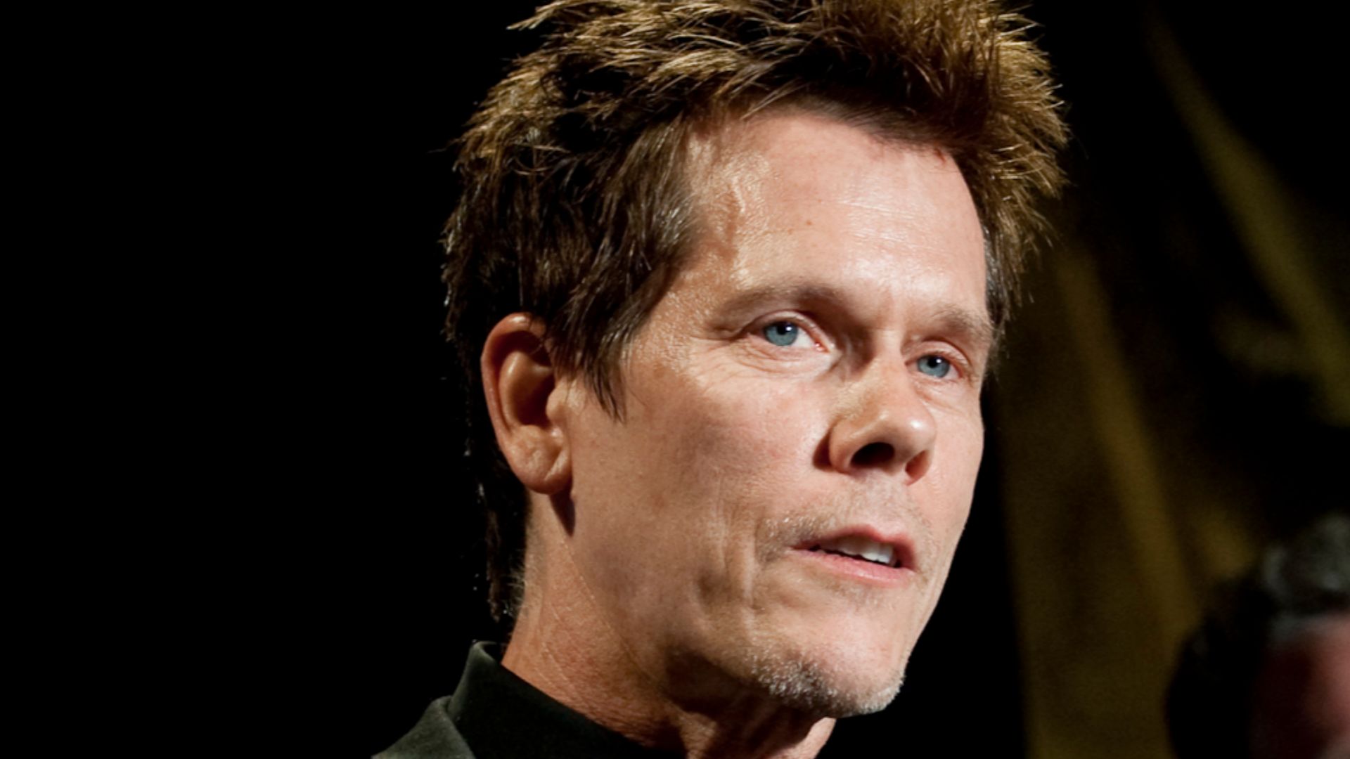 Kevin Bacon addresses audience members after being presented the Merit Service Award, along with his brother Michael Bacon, at the annual USO Gala at the Ritz Carlton in Arlington, Virginia on April 14, 2010.