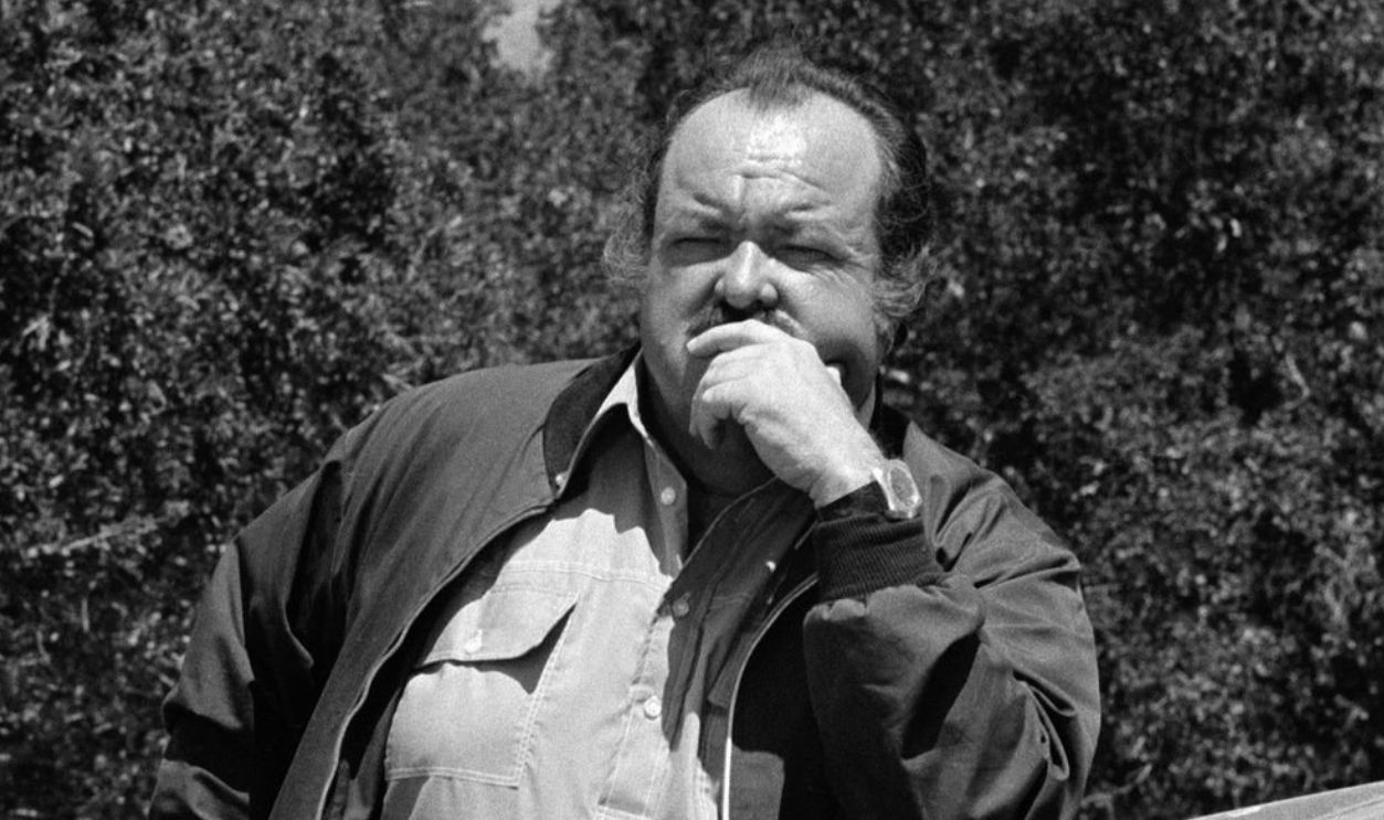 Promotional portrait of American actor William Conrad (1920 - 1994) with his elbow on the hood of vehicle in a scene from an episode of the television drama 'Cannon' entitled 'Child of Fear,' California, July 3, 1972. The episode was originally broadcast on November 15, 1972. 
