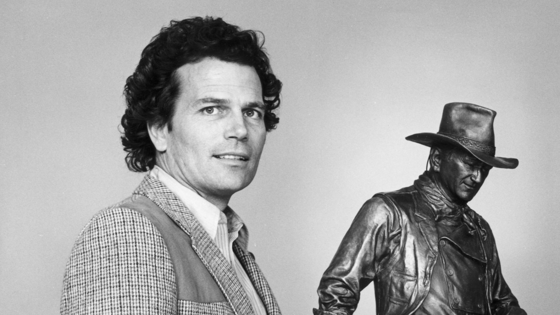 Patrick and Michael Wayne with a model of the proposed statue of their father, John Wayne. to be placed at John Wayne Airport, circa 1981.
There are no known copyright restrictions on this image. All future uses of this photo should include the courtesy l