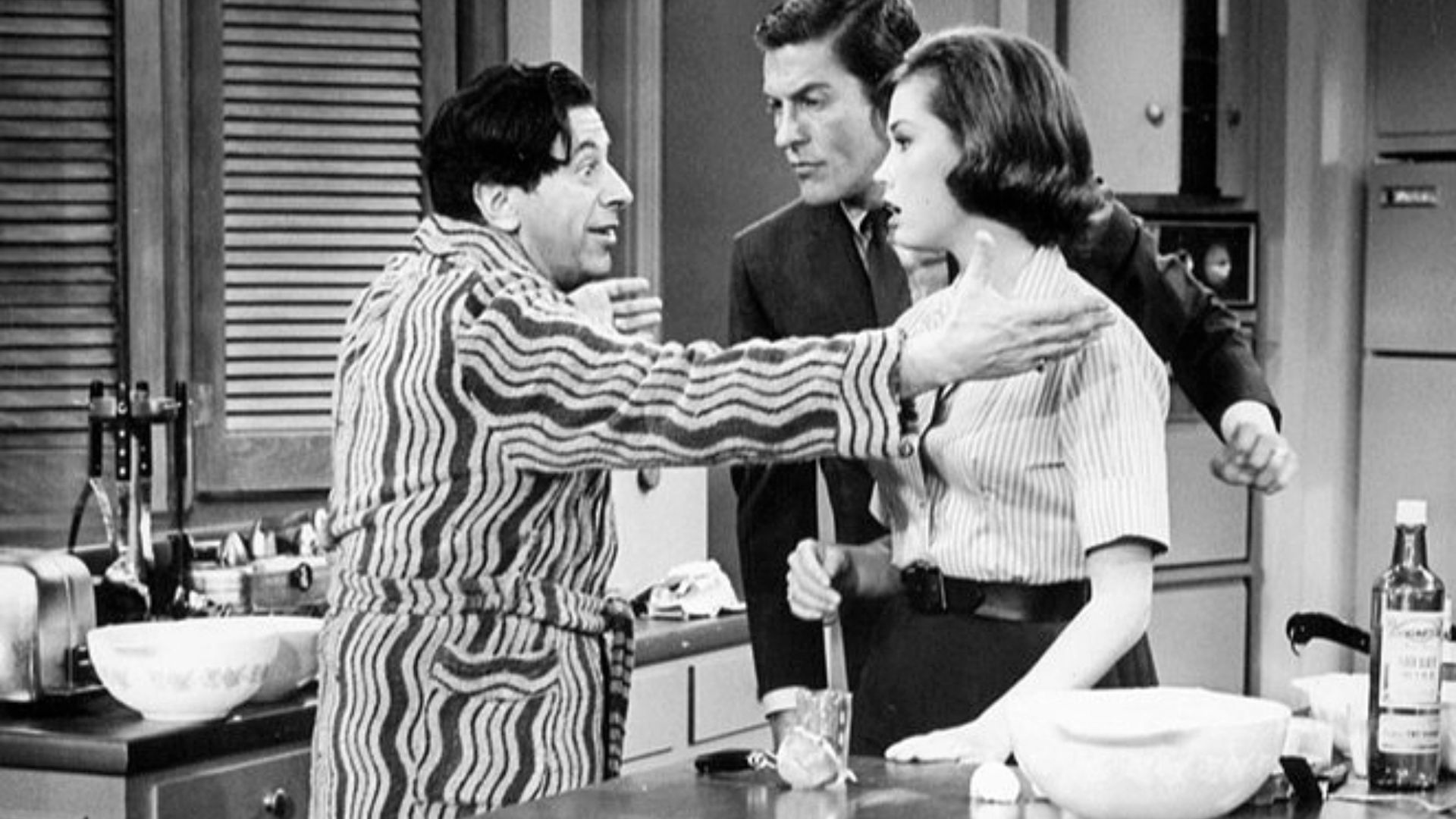 Publicity photo from The Dick Van Dyke Show. Pictured are Buddy (Morey Amsterdam) and Laura (Mary Tyler Moore) and Rob (Dick Van Dyke) Petrie. When Buddy's wife, Pickles, goes out of town, Buddy becomes the Petrie's house guest.