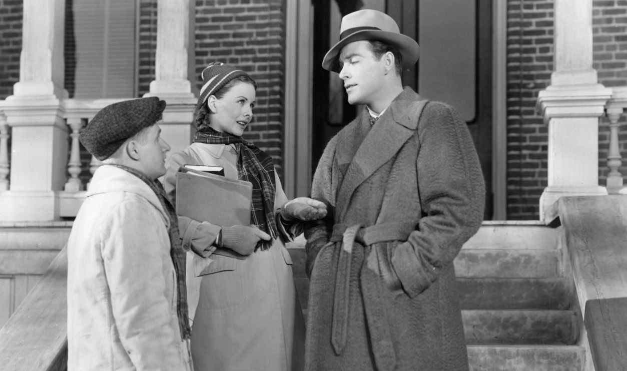 Conrad Janis looking up as Jeanne Crain puts her hand out to Glenn Langan in a scene from the film 'Margie', 1946. 