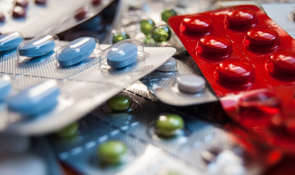 Close-up of various colored medication pills in blister packs