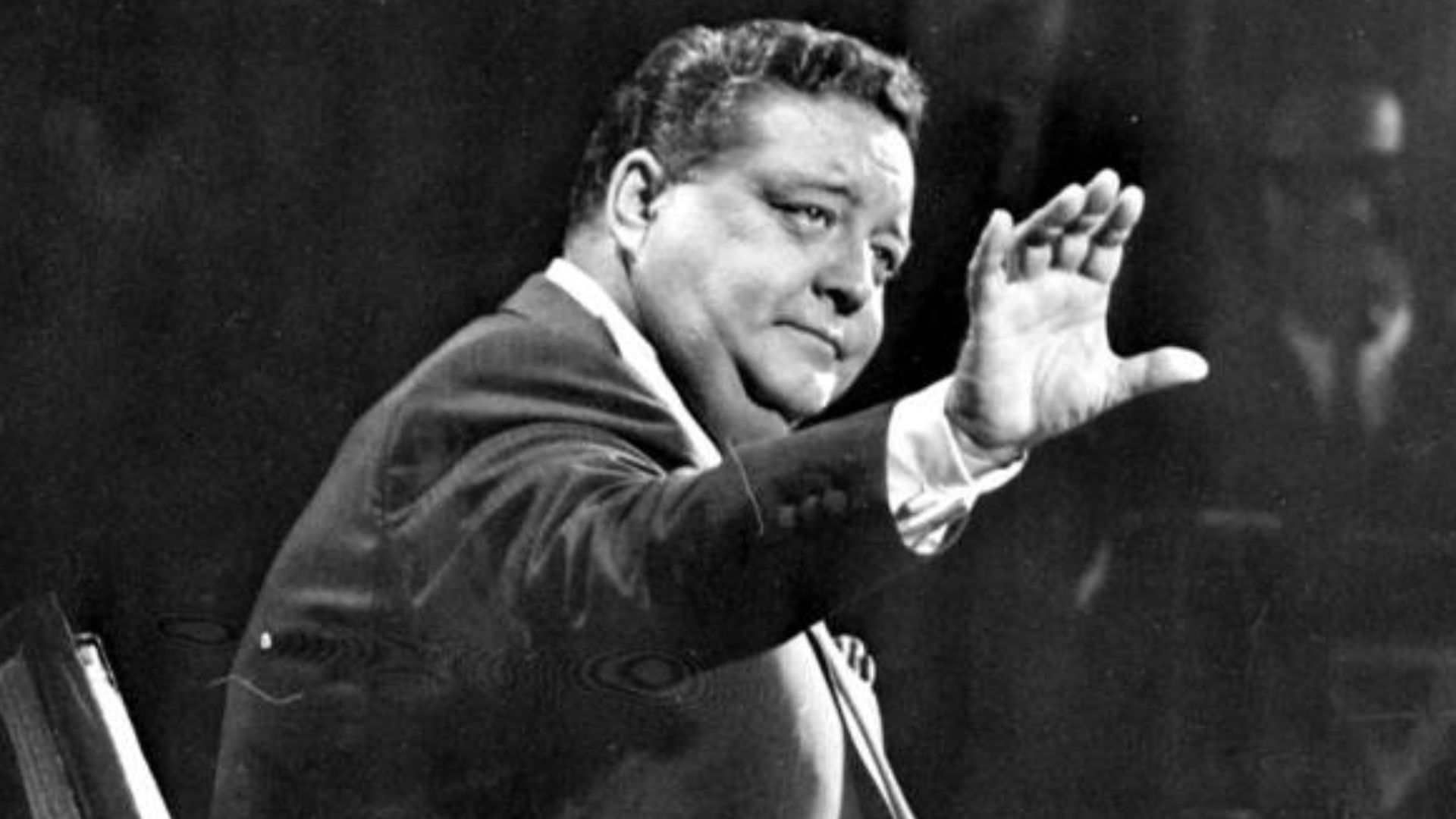 Medium shot of John Herbert Gleason sitting on a set