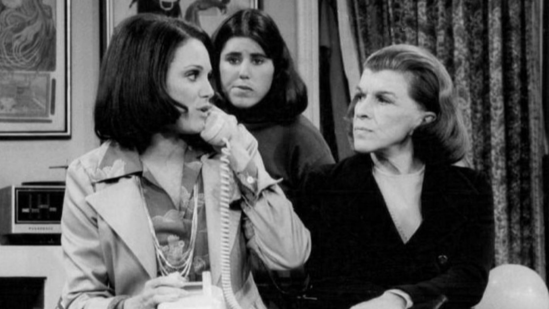 Photo from the premiere of the television program Rhoda.  Valerie Harper (Rhoda) is on phone as Julie Kavner (her sister, Brenda), and Nancy Walker (her mother, Ida), look on.