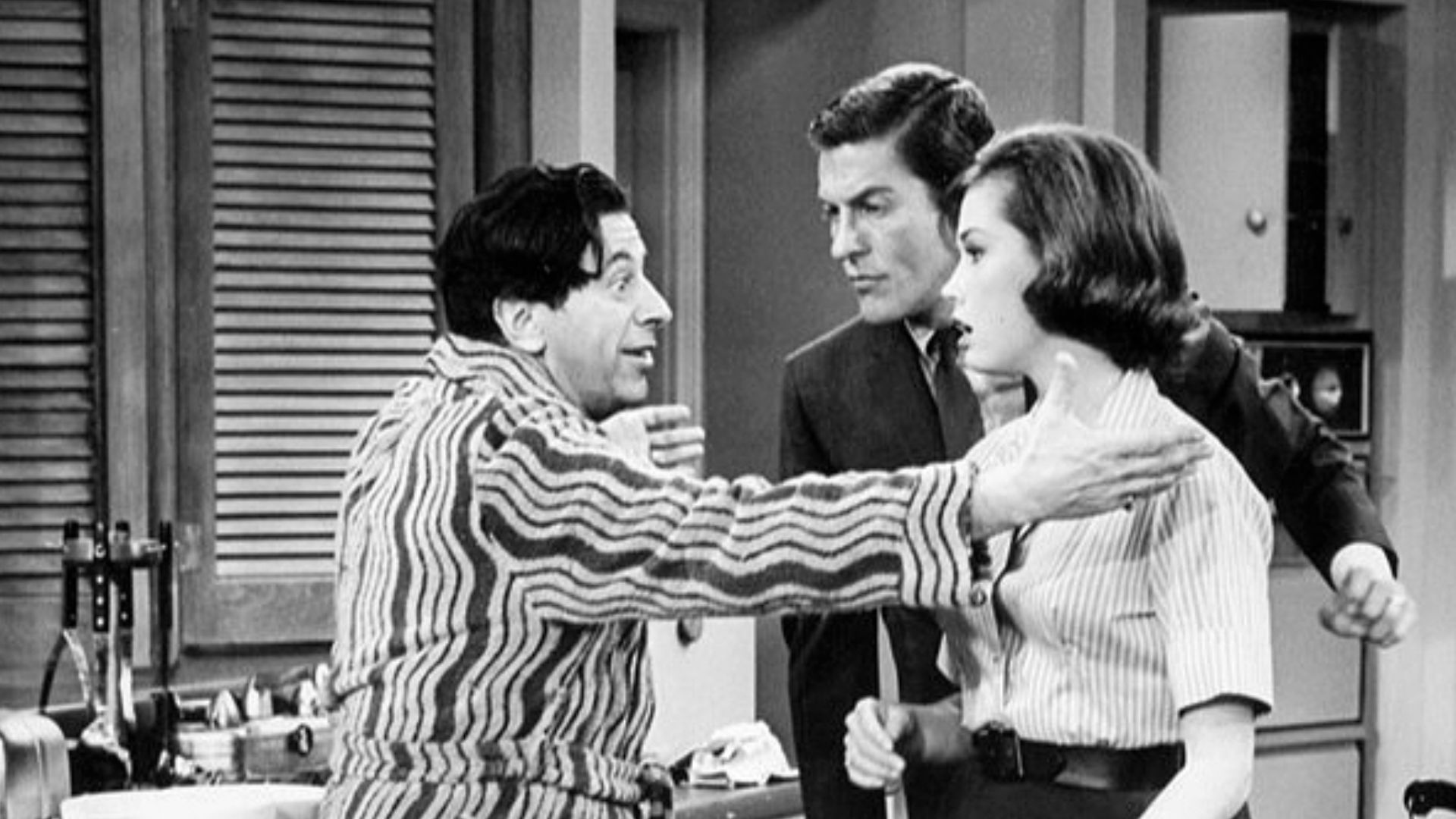 Publicity photo from The Dick Van Dyke Show. Pictured are Buddy (Morey Amsterdam) and Laura (Mary Tyler Moore) and Rob (Dick Van Dyke) Petrie. When Buddy's wife, Pickles, goes out of town, Buddy becomes the Petrie's house guest.