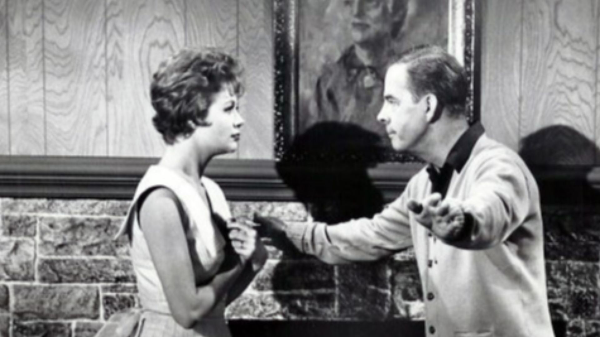 Photo of Harry Morgan and Cara Williams as Pete and Gladys Porter from the television program Pete and Gladys.  As the Porters move into their new home, they can't seem to agree about where pictures should be hung.