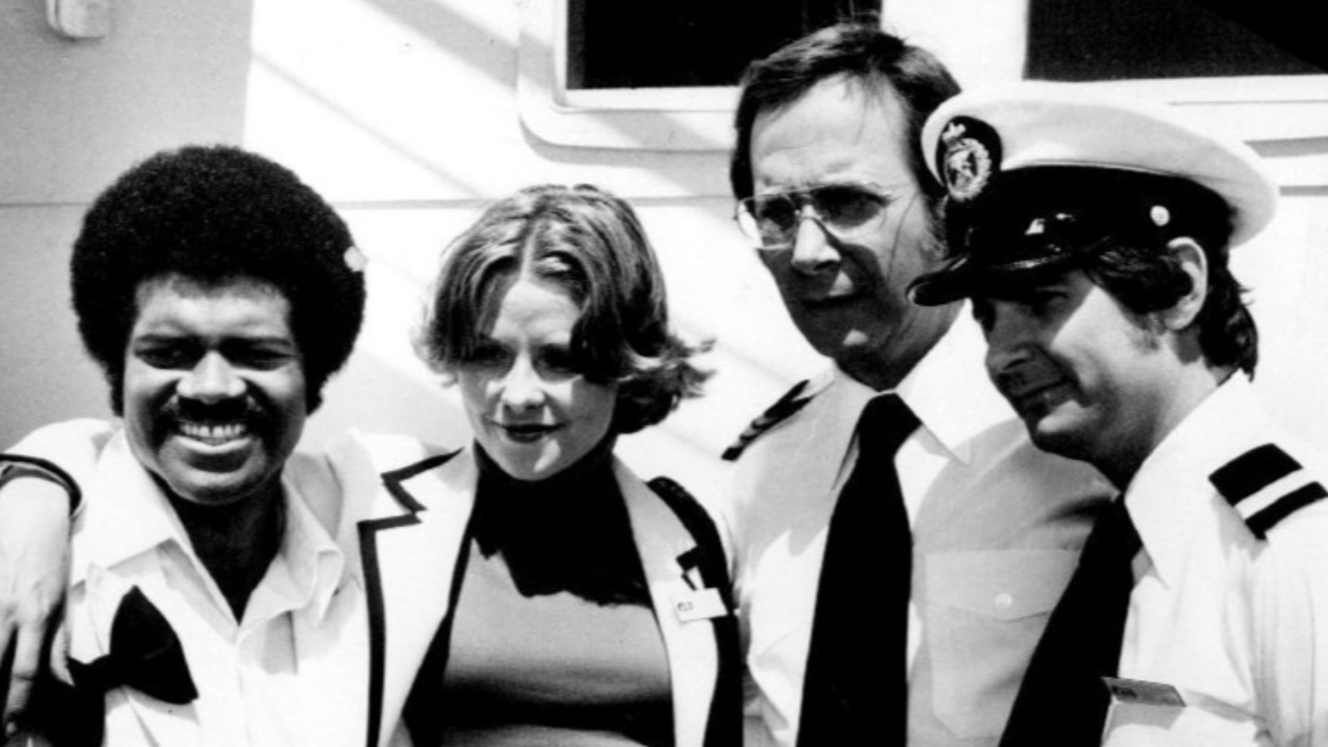 Photo of The Love Boat cast except Gavin MacLeod (Captain Stubing).  From left-Ted Lange (Isaac Washington), Lauren Tewes (Julie McCoy), Bernie Kopell (Adam Bricker), and Fred Grandy (Gopher).