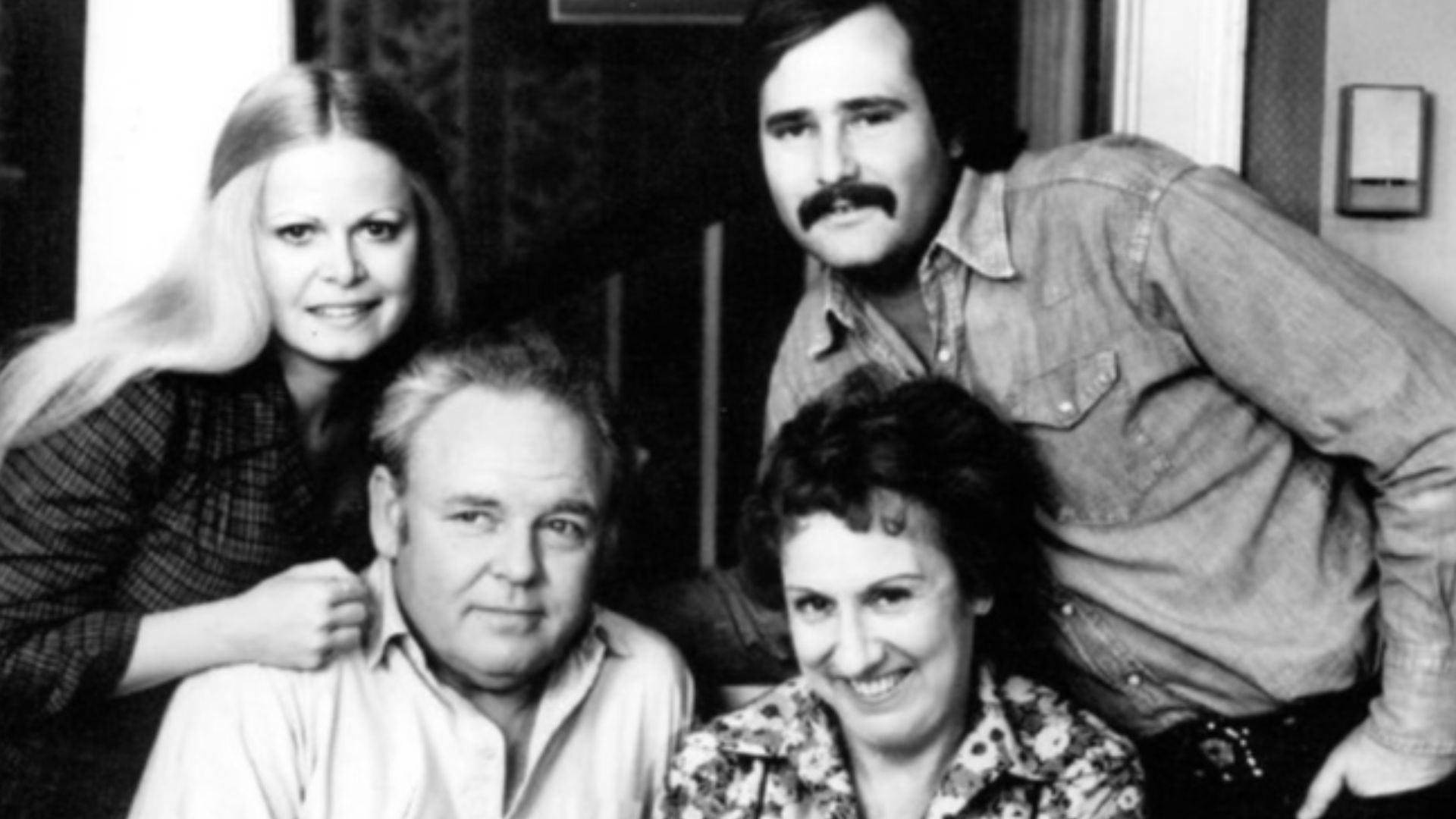 Photo of the Cast of the television program All in the Family.  Standing are Sally Struthers (Gloria) and Rob Reiner (Michael); seated are Archie (Carroll O'Connor) and Edith (Jean Stapleton), who is holding the child who played the Bunker's grandson, Joe