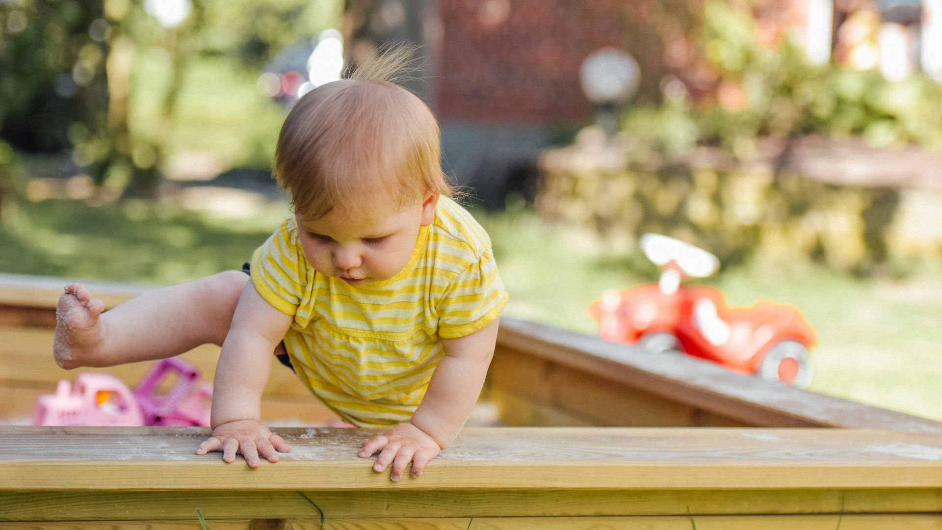 baby trying to get out of his crib