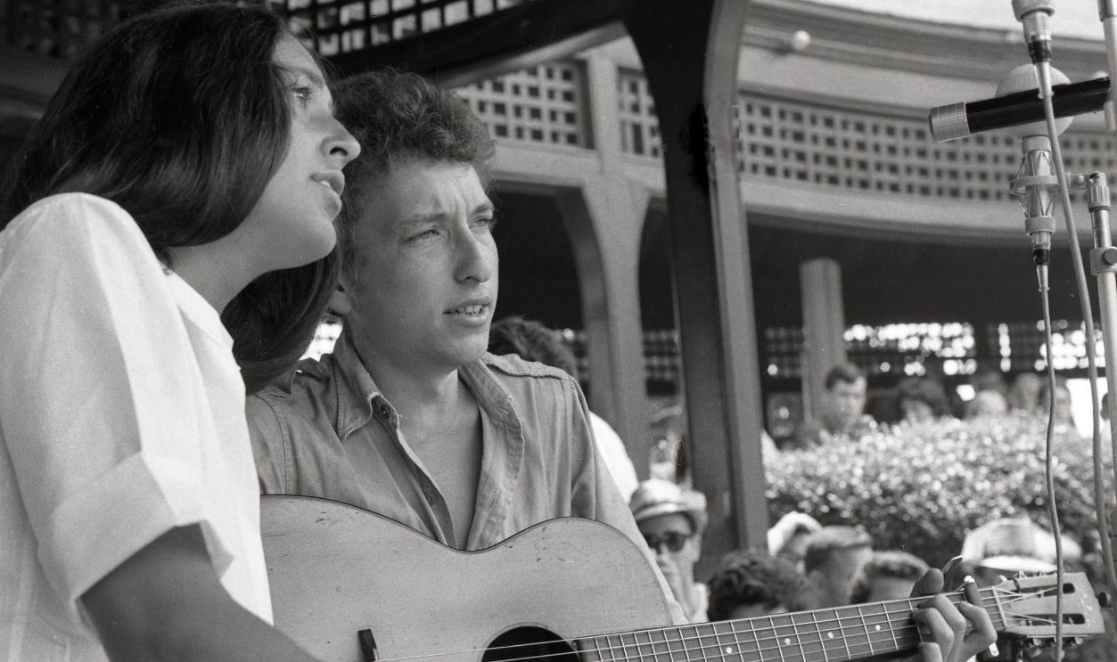 Portrait of folk musicians Joan Baez and Bob Dylan taken while they shared the stage during a duet at the Newport Folk Festival, Rhode Island, 1963. This was Bob Dylan's first performance on the Newport stage.