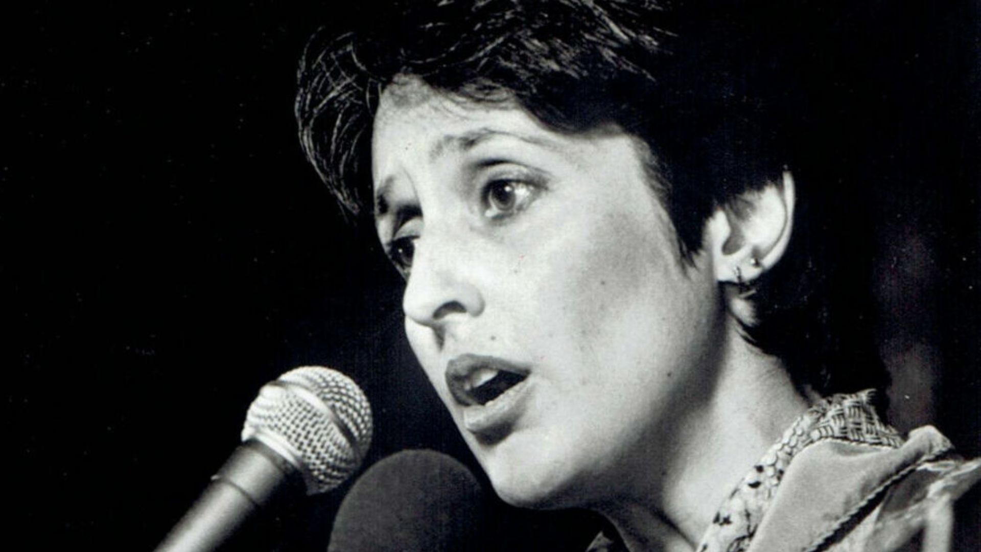 Singer Joan Baez singing in concert for publicity studio portrait during tour of Argentina, Brazil and Chile.