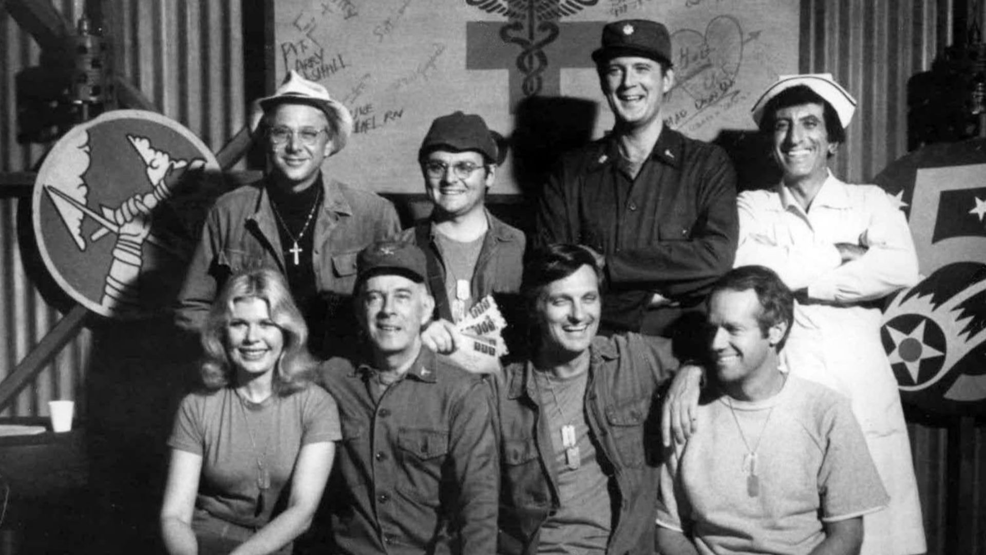 Cast photo from M*A*S*H for 1977.  Front row from left-Loretta Swit, Harry Morgan, Alan Alda, Mike Farrell.  Back row from left-William Christopher, Gary Burghoff, David Ogden Stiers, and Jamie Farr.