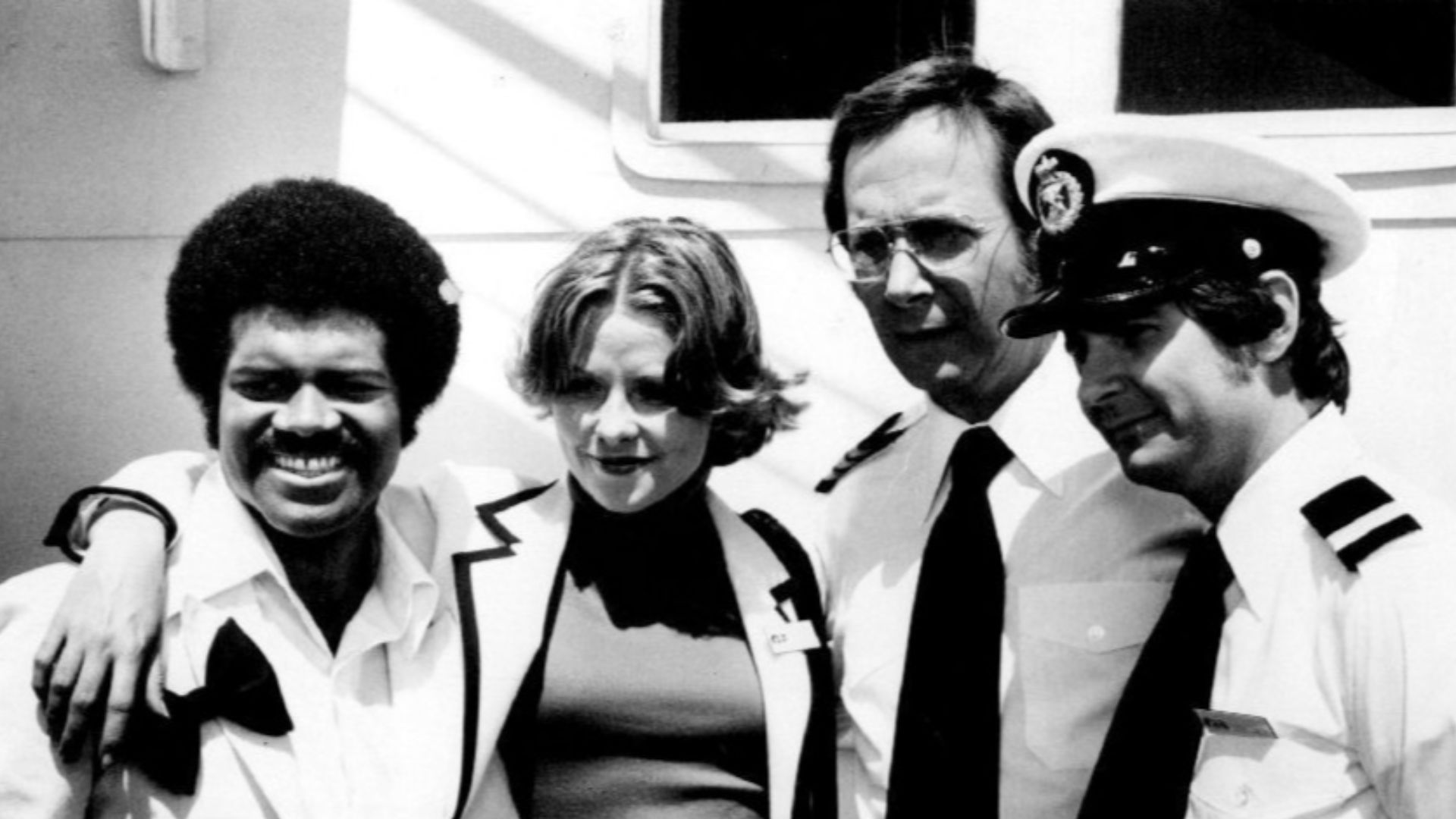 Photo of The Love Boat cast except Gavin MacLeod (Captain Stubing).  From left-Ted Lange (Isaac Washington), Lauren Tewes (Julie McCoy), Bernie Kopell (Adam Bricker), and Fred Grandy (Gopher).