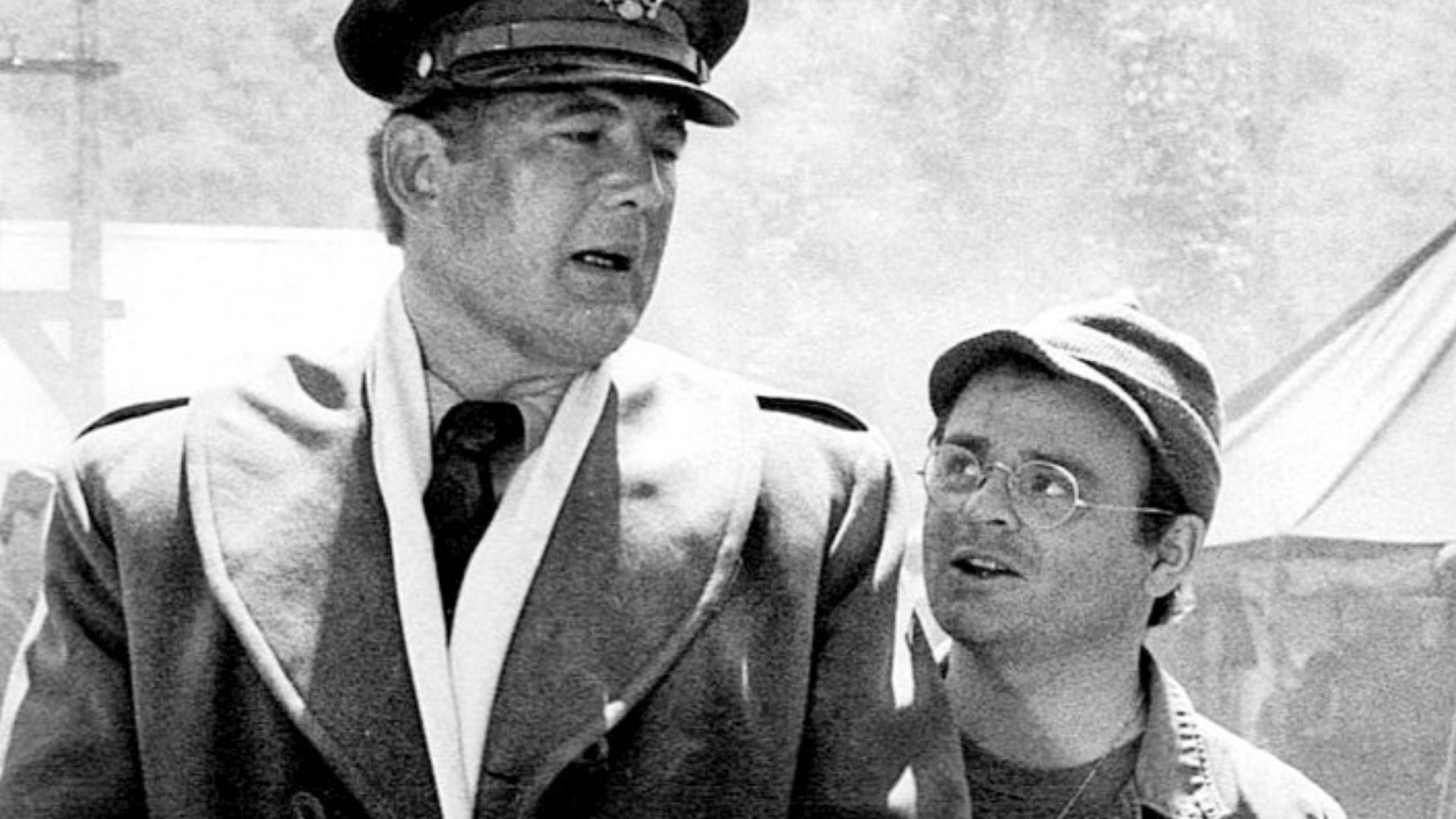 Photo of David Ogden Stiers as Major Charles Winchester and Gary Burghoff as Radar O'Reilly from M*A*S*H.  This is the first appearance of the Charles Winchester character on M*A*S*H.