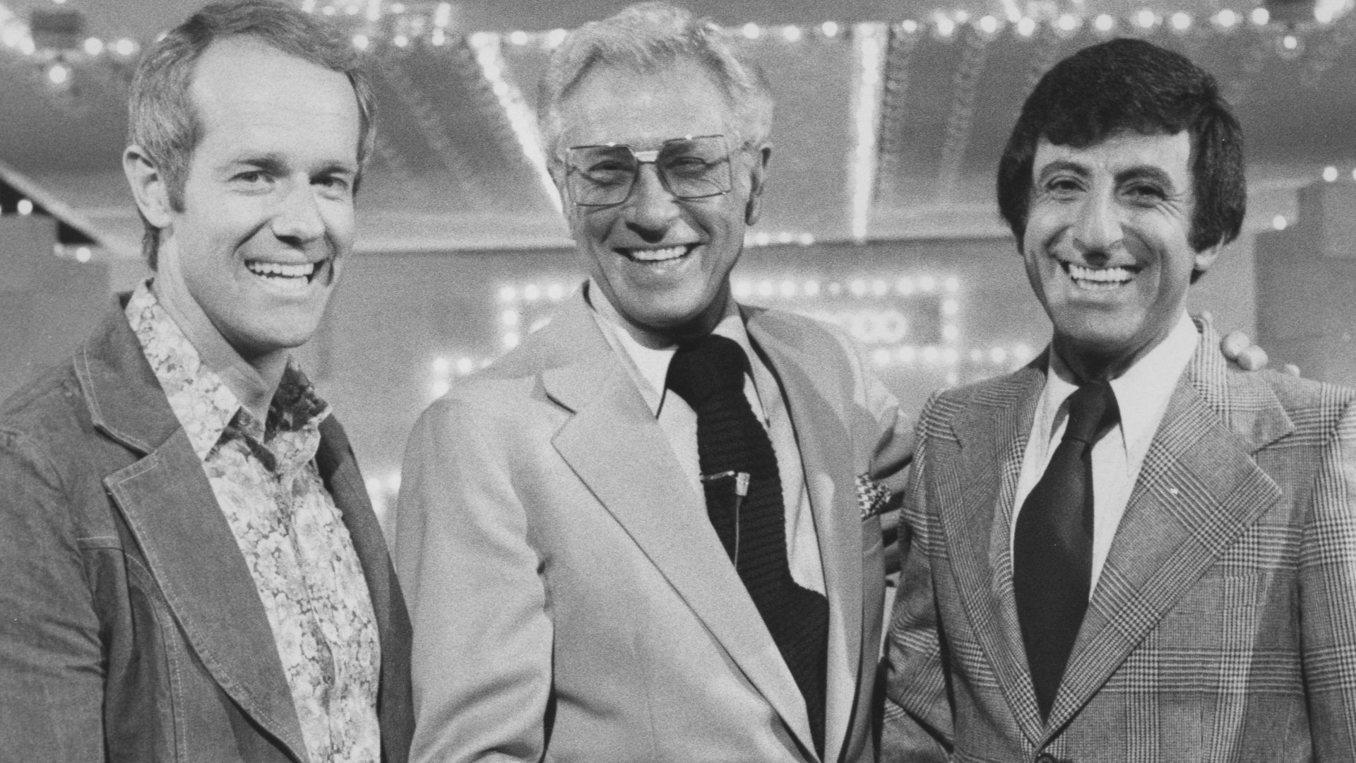 Publicity photo of game show Stumpers. Pictured are (left to right) M*A*S*H star Mike Farrell, game show host Allen Ludden, and another M*A*S*H star Jamie Farr. Celebrities were supposed to appear on the game show on October 18–22, 1976, 10:30am–11am PT /