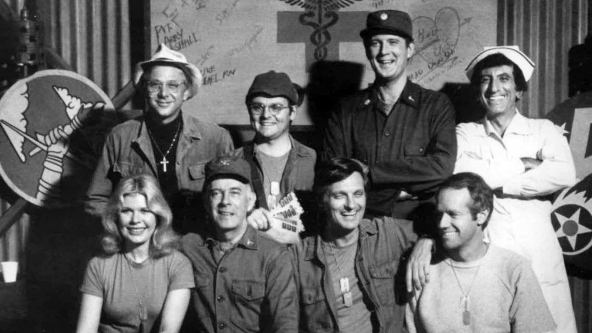 Cast photo from M*A*S*H for 1977.  Front row from left-Loretta Swit, Harry Morgan, Alan Alda, Mike Farrell.  Back row from left-William Christopher, Gary Burghoff, David Ogden Stiers, and Jamie Farr.