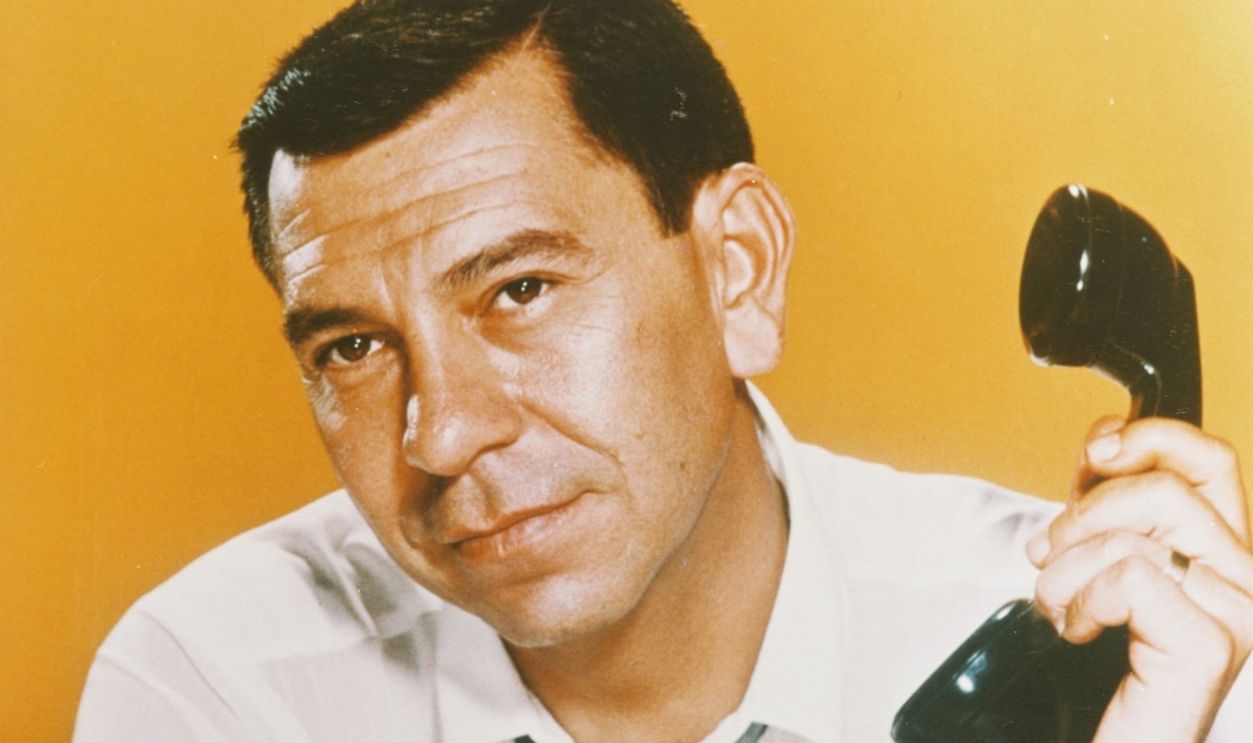Jack Webb (1920-1982), US actor, wearing pointing with one hand while holding a telephone receiver in the other in a publicity still issued for the US television series, 'Dragnet 1967', USA, 1967. The poice drama starred Webb as 'Sergeant Joe Friday'.