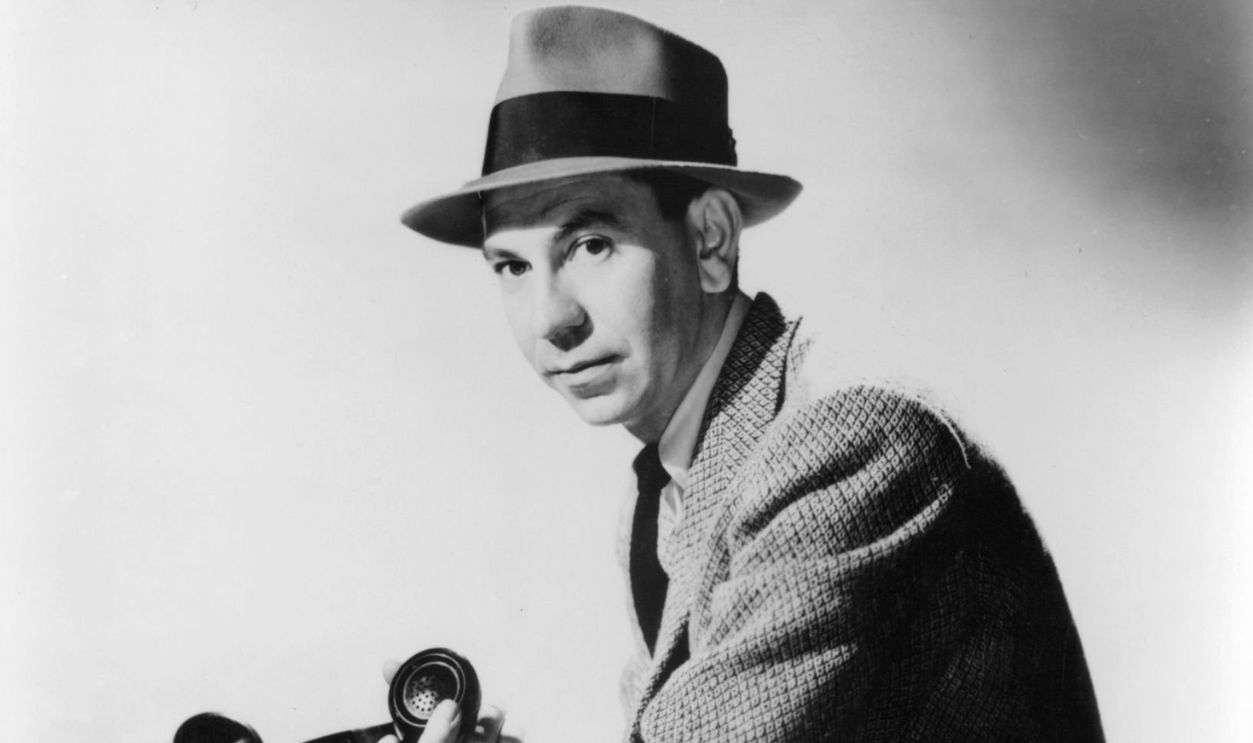 Jack Webb holding gun and phone in publicity portrait for the film 'Dragnet', Circa 1955.
