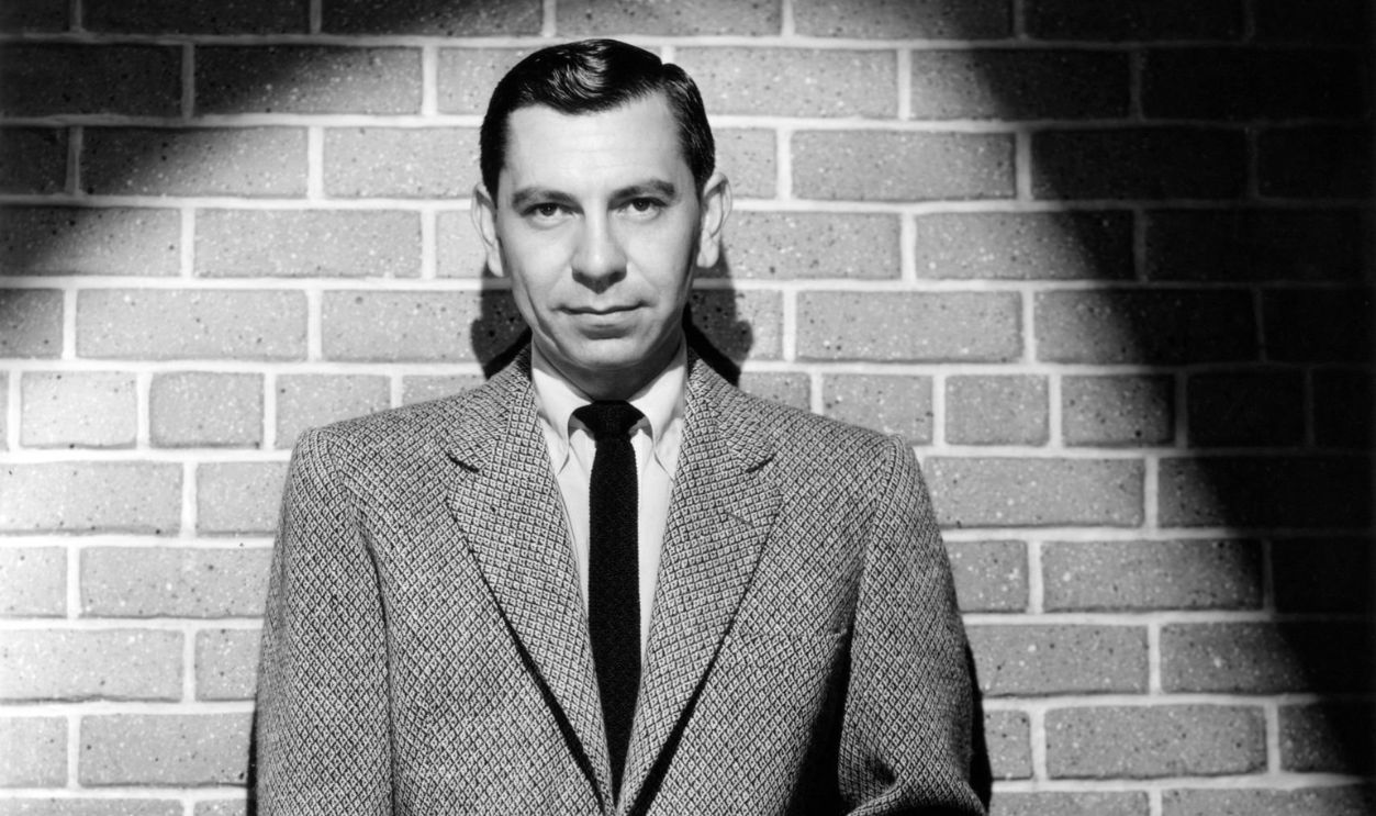 Jack Webb standing in spotlights for a 1959 publicity pose for his TV series Dragnet.