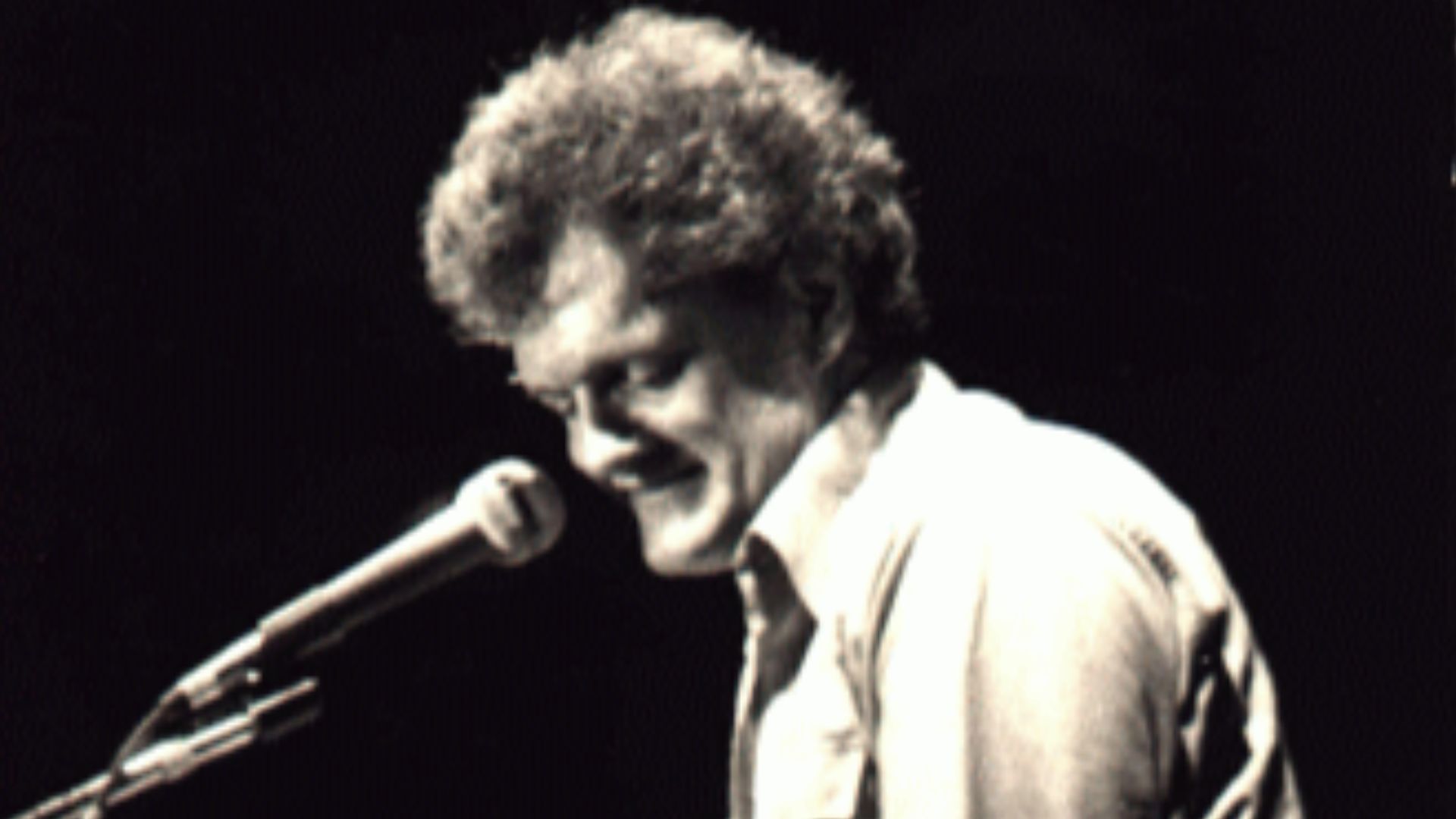 Harry Chapin performing with guitar in concert