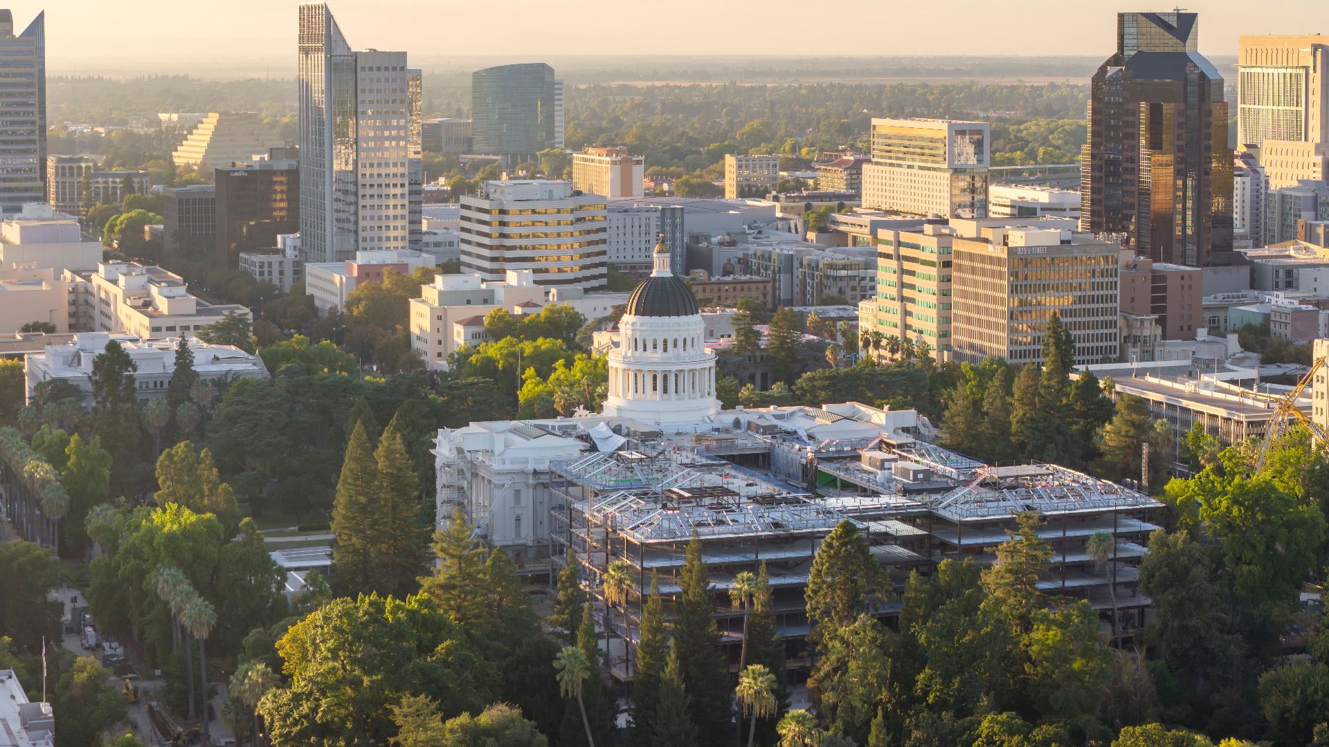Aerial view of Sacramento cityscape featuring the California State Capitol at sunset.