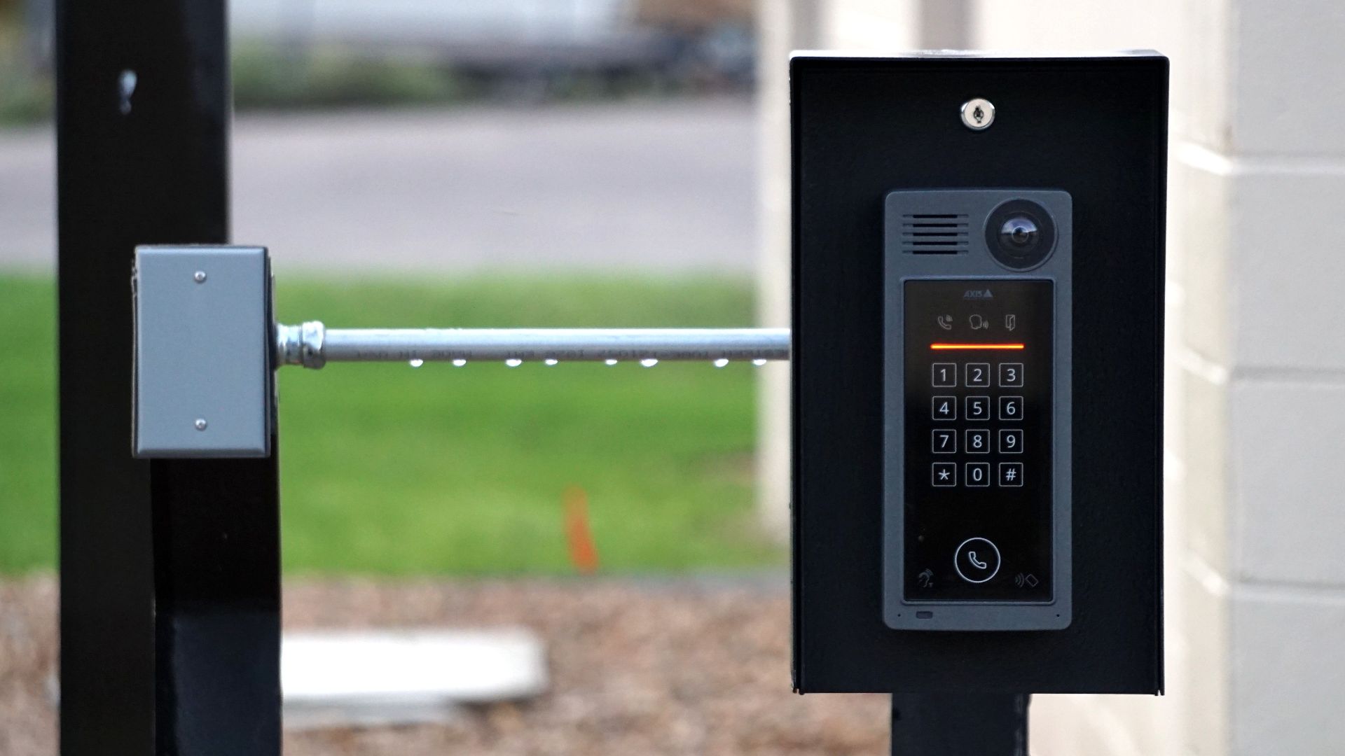 Outdoor intercom mounted at a residential building entrance, ensuring security and communication.