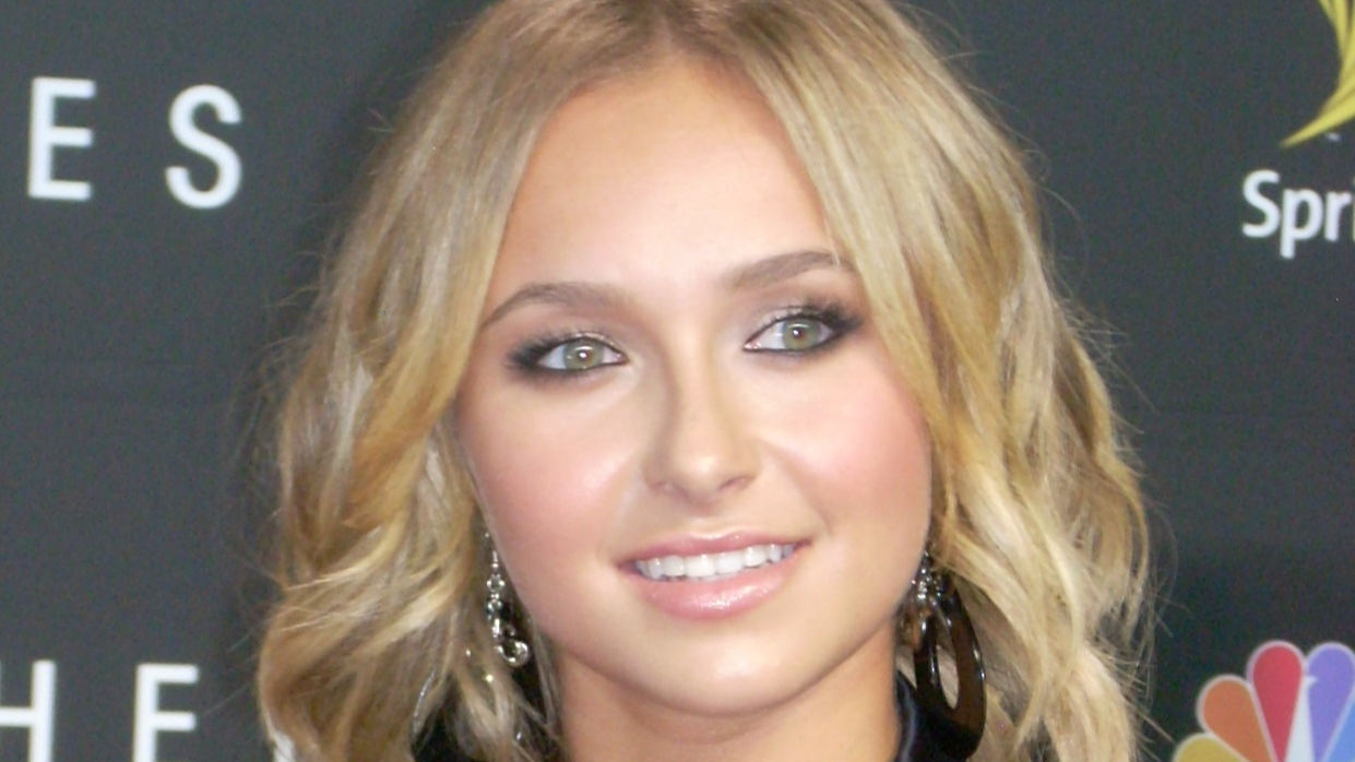 Hayden Panettiere wearing black suit and earrings ,smiling and looking at side  - 2008