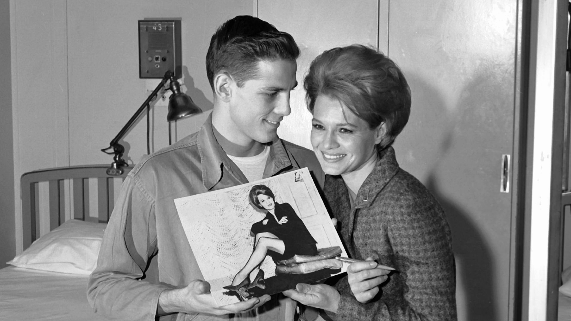 Actress Angie Dickinson signs an autograph for a patient at Fitzsimons Army Hospital in 1964.