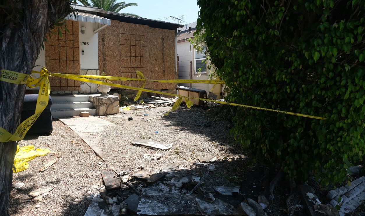Getty Images - 1242391462 - Charred debris and caution tape are seen at the site where US actress Anne Heche crashed into a home in Mar Vista, California on August 8, 2022. - US actress Anne Heche has been hospitalized in critical condition after crashing her car into a Los Angeles home, US media reported on August 5, 2022. The 53-year-old actress initially crashed into an apartment building garage before driving off, according to images collected by TMZ.