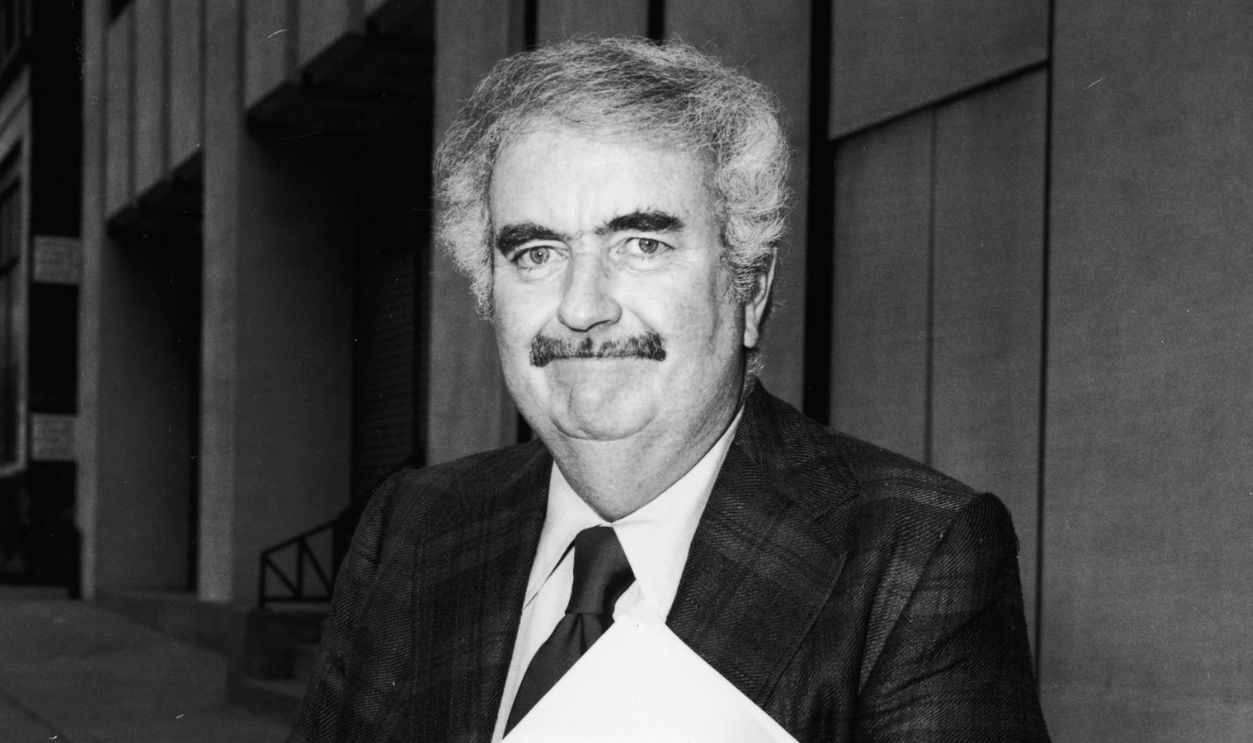 American children's television host Robert (Bob) Keeshan (1927 - 2004) (host of 'Captain Kangaroo') (1927 - 2004) walks on the street, carrying a folder, New York City, July 1974. (