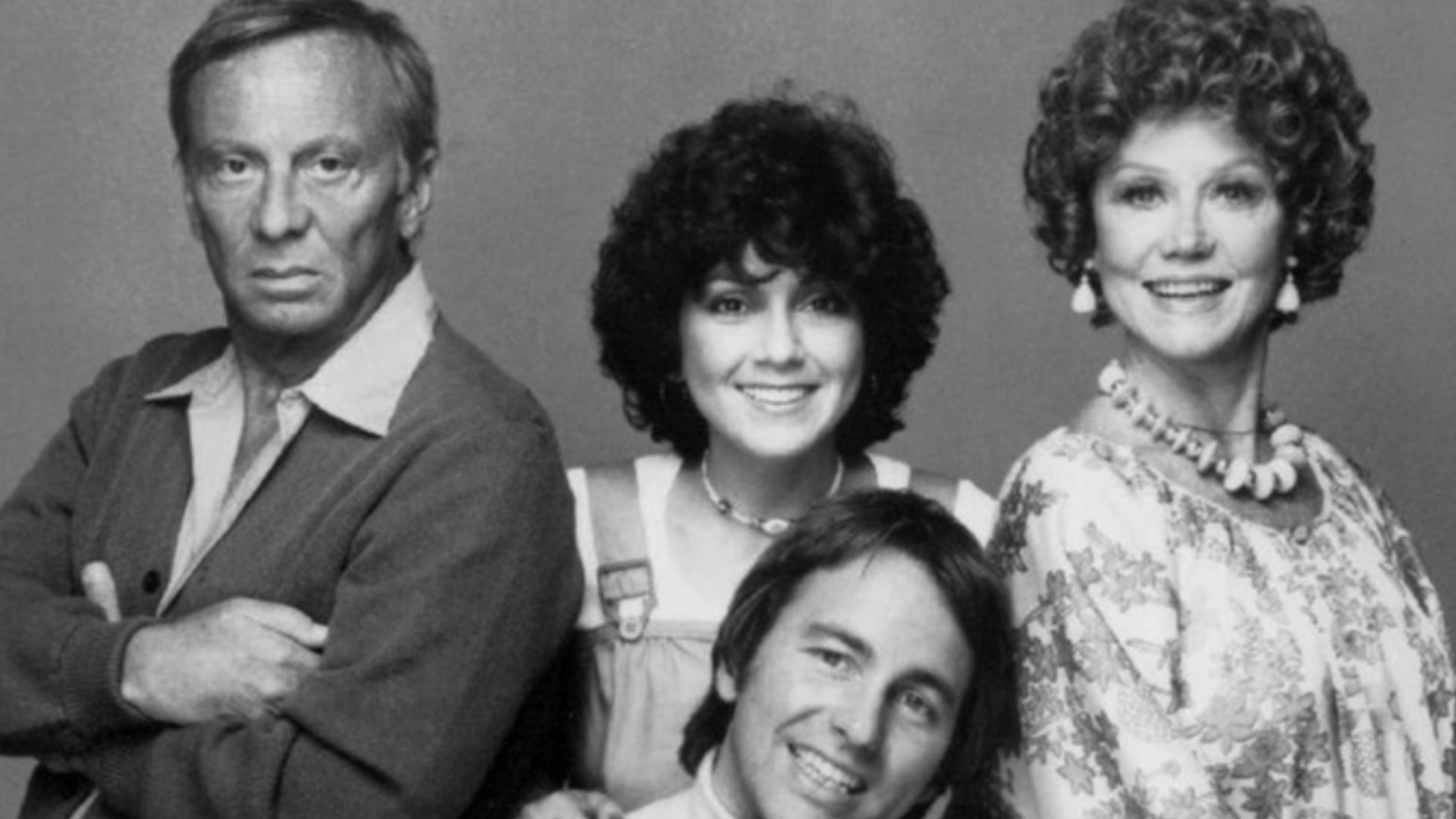 Cast photo of the television program Three's Company as it began its second season in September 1977.  Standing, from left: Norman Fell (Stanley Roper), Joyce DeWitt (Janet Wood), Audra Lindley (Helen Roper).  Seated: John Ritter (Jack Tripper), Suzanne S