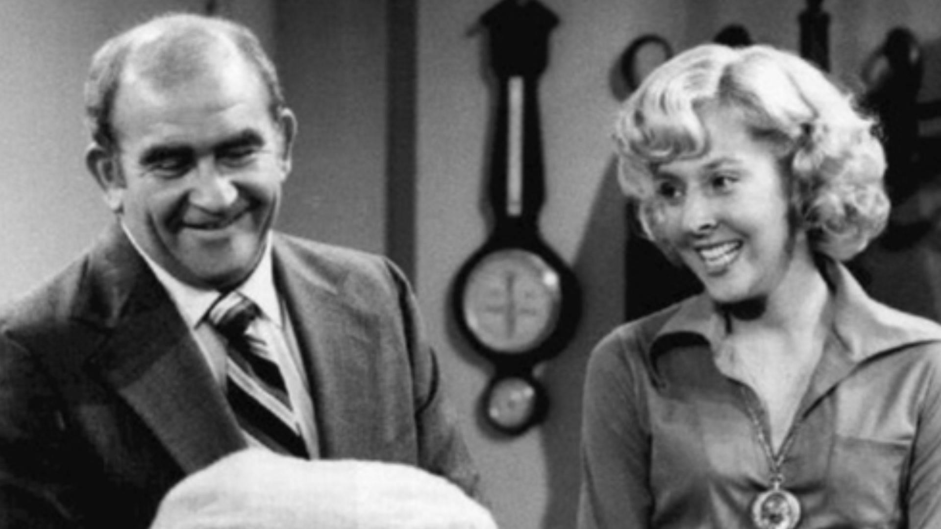 Photo of Ed Asner as Lou Grant and Georgia Engel as Georgette Baxter.  Lou brings his namesake, Mary Lou Baxter, a gift.  Lou and Mary helped deliver the baby at Mary's apartment when Georgette unexpectedly went into labor there.